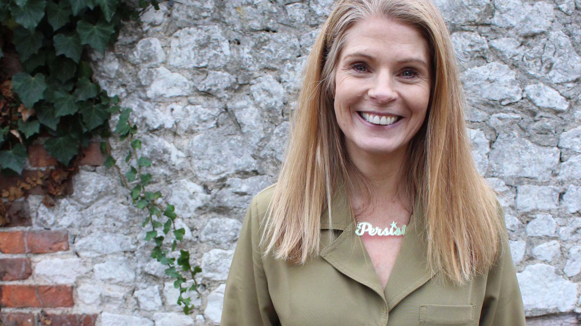 Sarah Day, the founder of Wear and Resist wears a Persist necklace