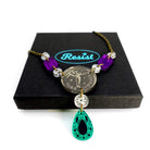 A close up of the Angel of Freedom necklace on top of a Wear and Resist gift box.