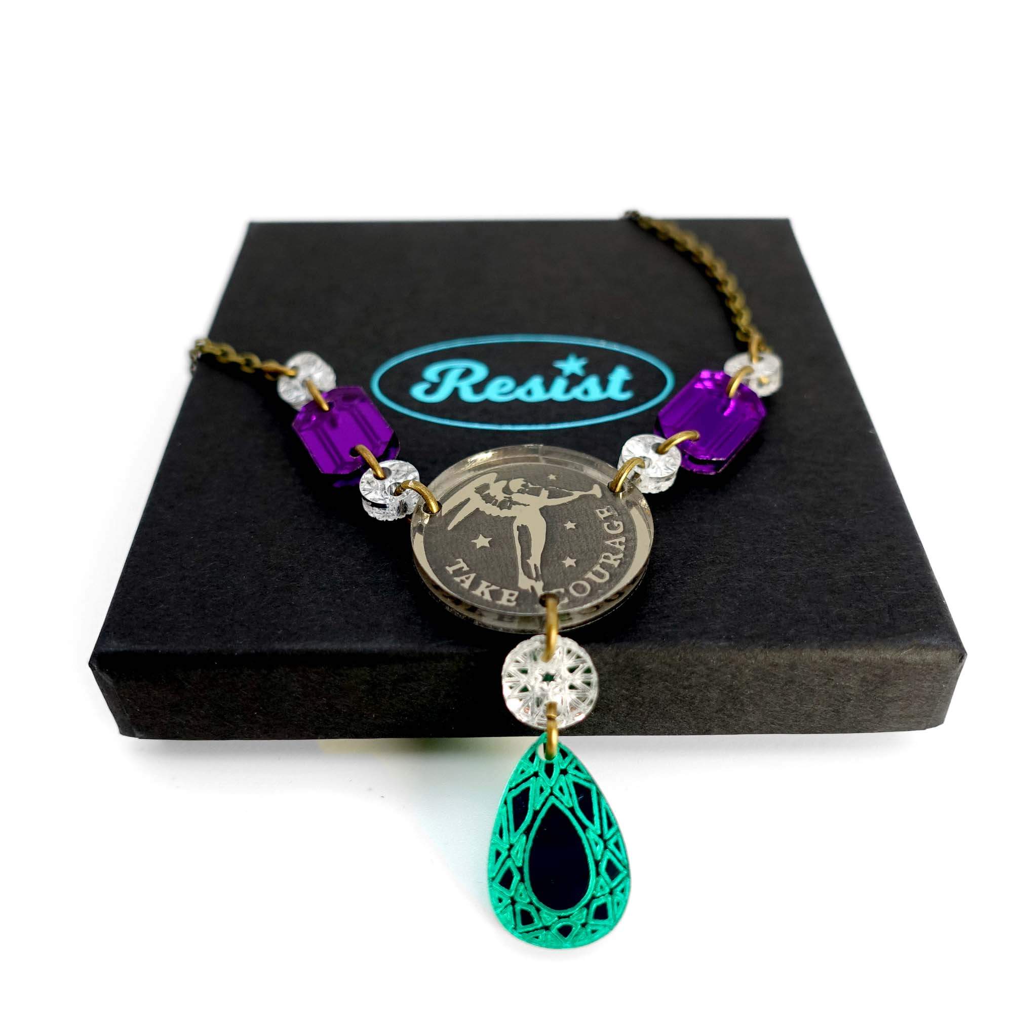 A close up of the Angel of Freedom necklace on top of a Wear and Resist gift box.