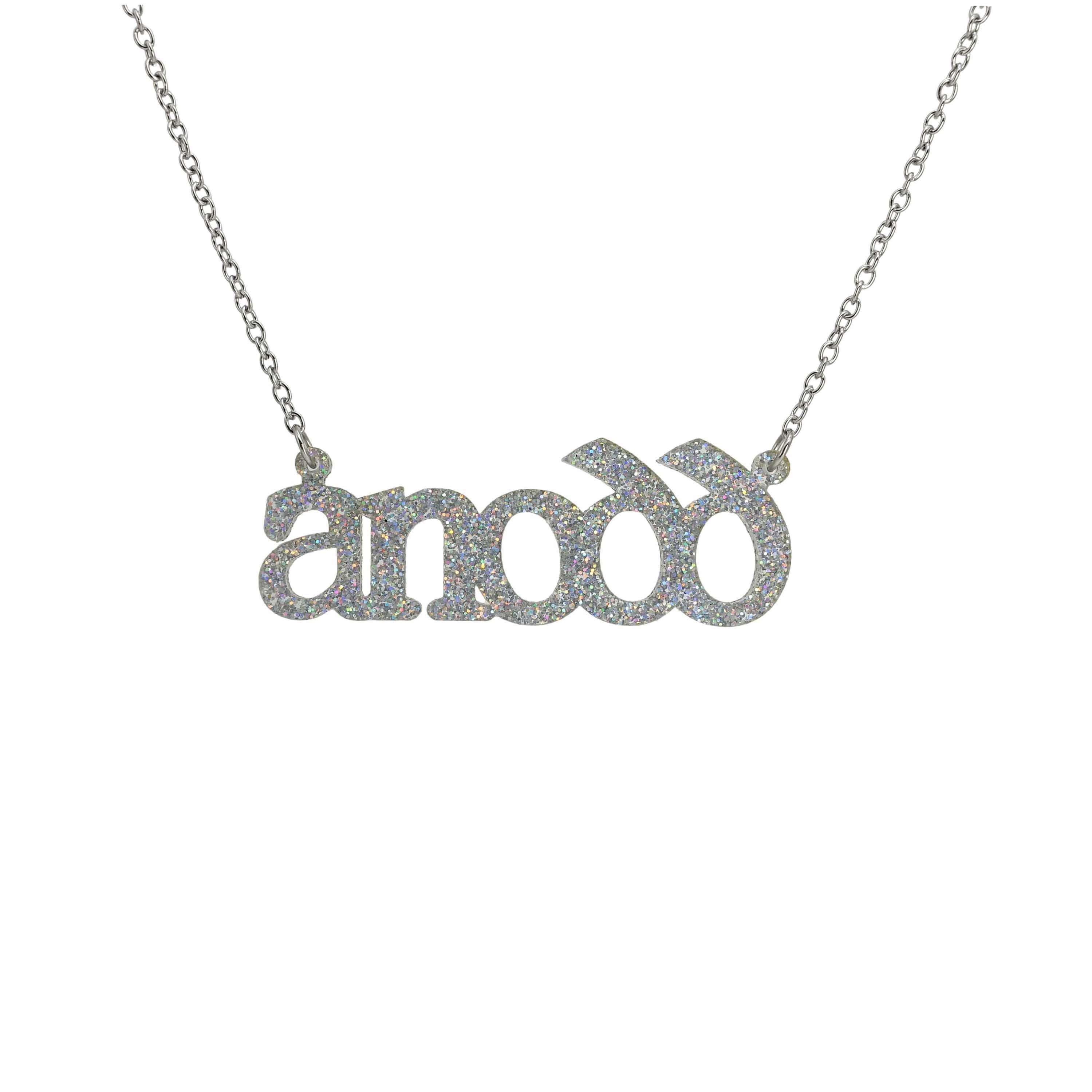 Anodd necklace for Welsh difficult women in silver glitter shown hanging on a stainless steel chain.
