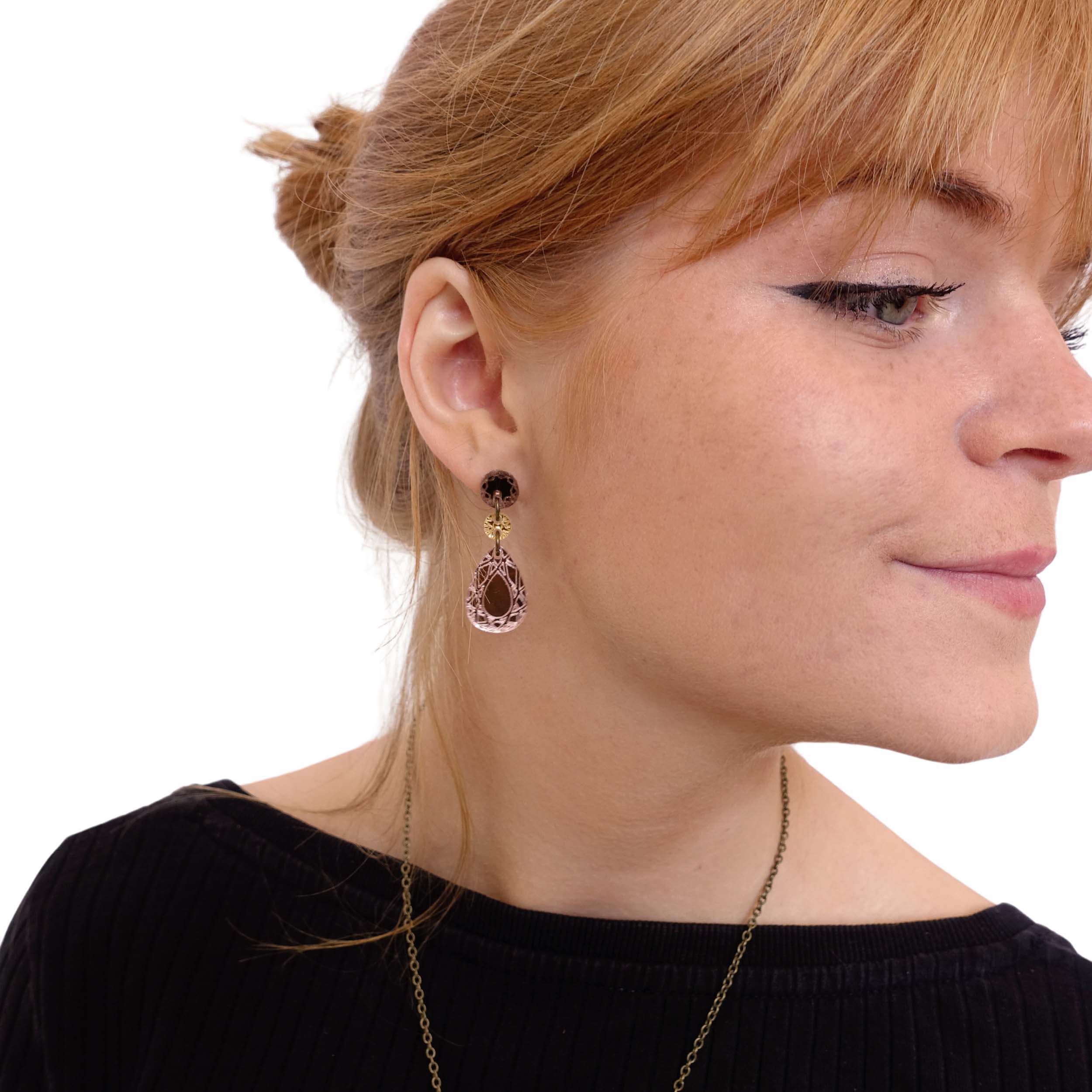 Eliza wears small rose-gold Belle Époque french drop earrings.