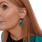 Sarah wears small electric green Belle Epoque French drop earrings.