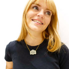 Eliza wears a bronze bespoke Mirror Cowboy necklace. You can have your favourite saying or quote engraved in a unique necklace made just for you.