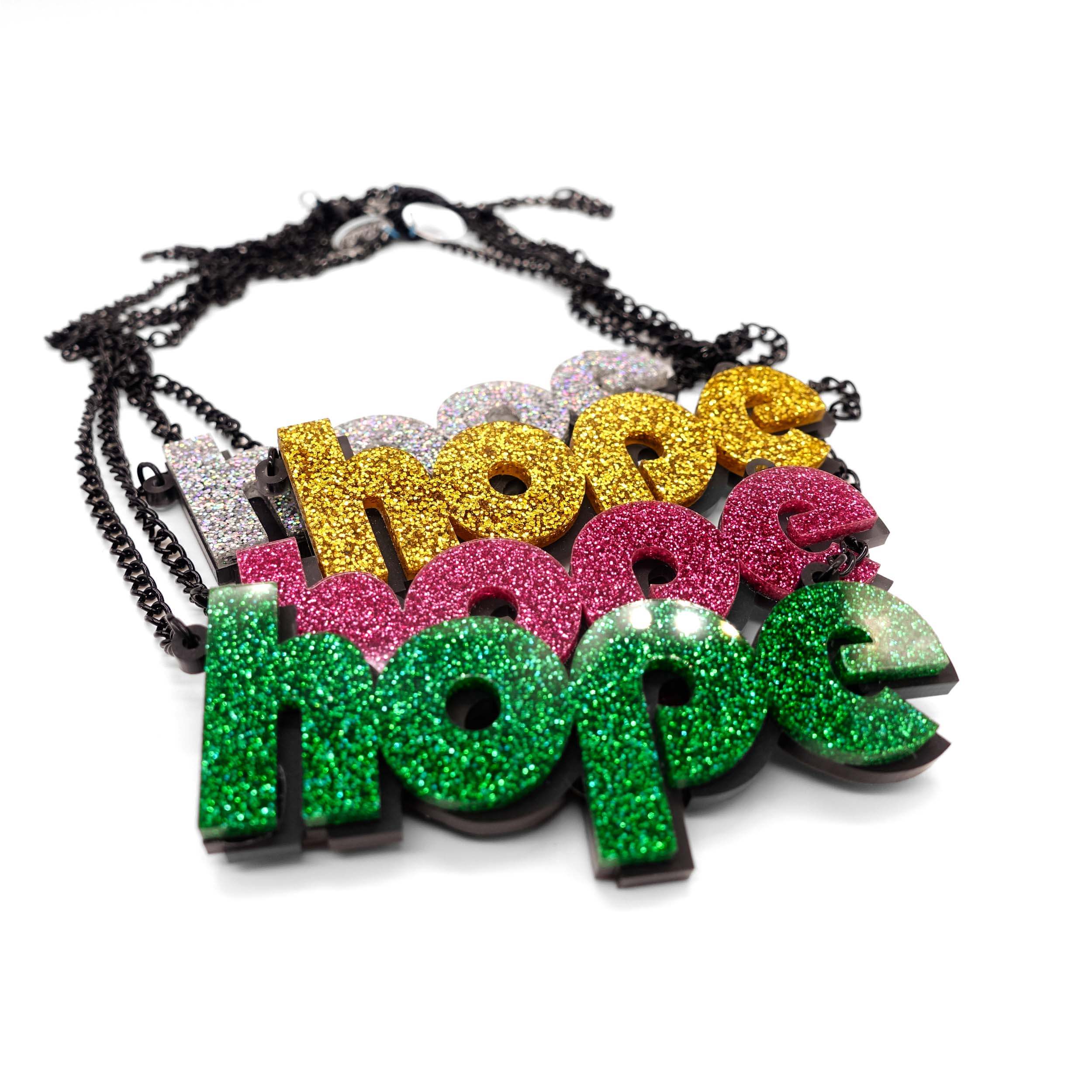 All four colours of the Hope statement necklaces shown laying on on a white surface.