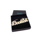 Bookish necklace in matte iridescent shown in a Wear and Resist gift box.