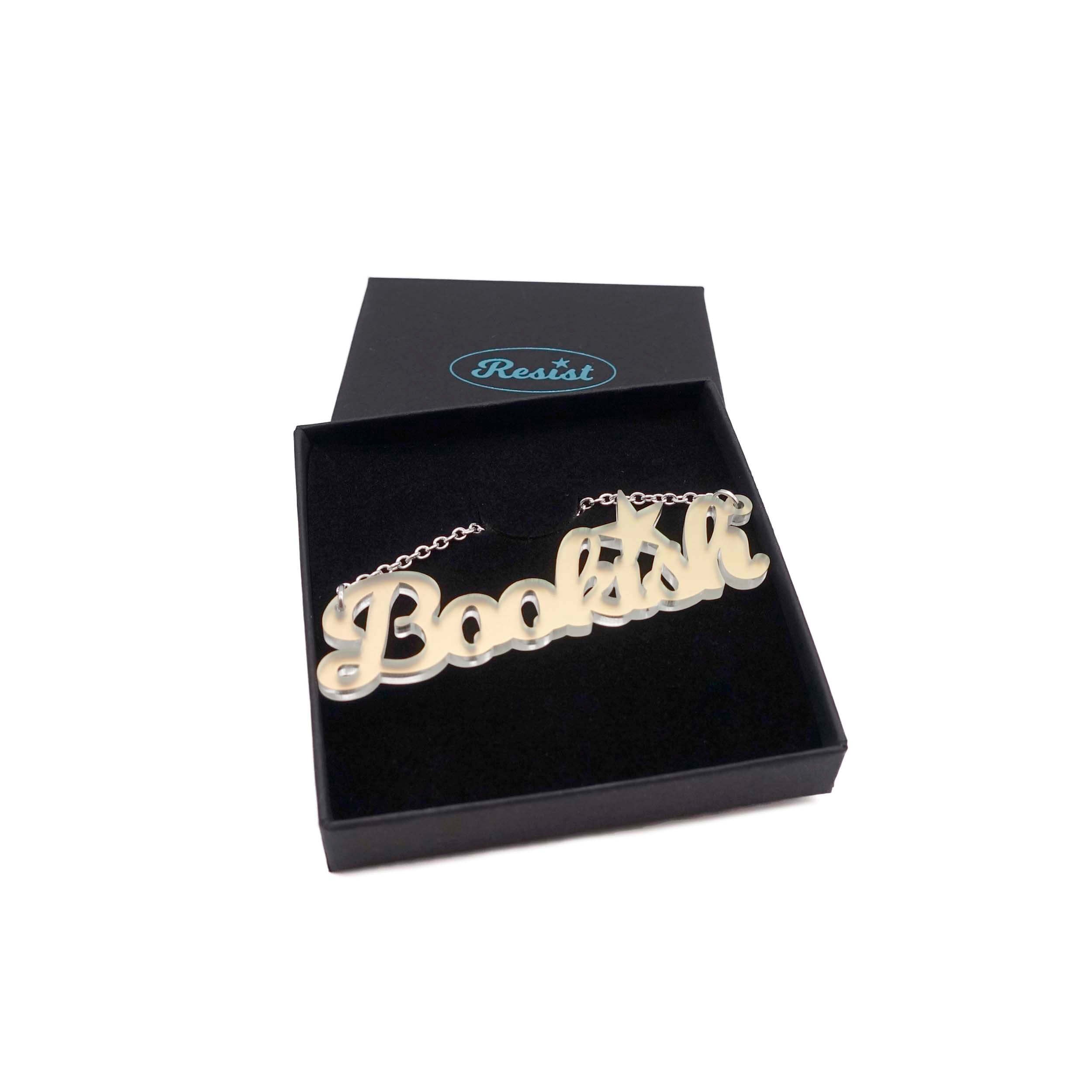 Bookish necklace in matte iridescent shown in a Wear and Resist gift box.