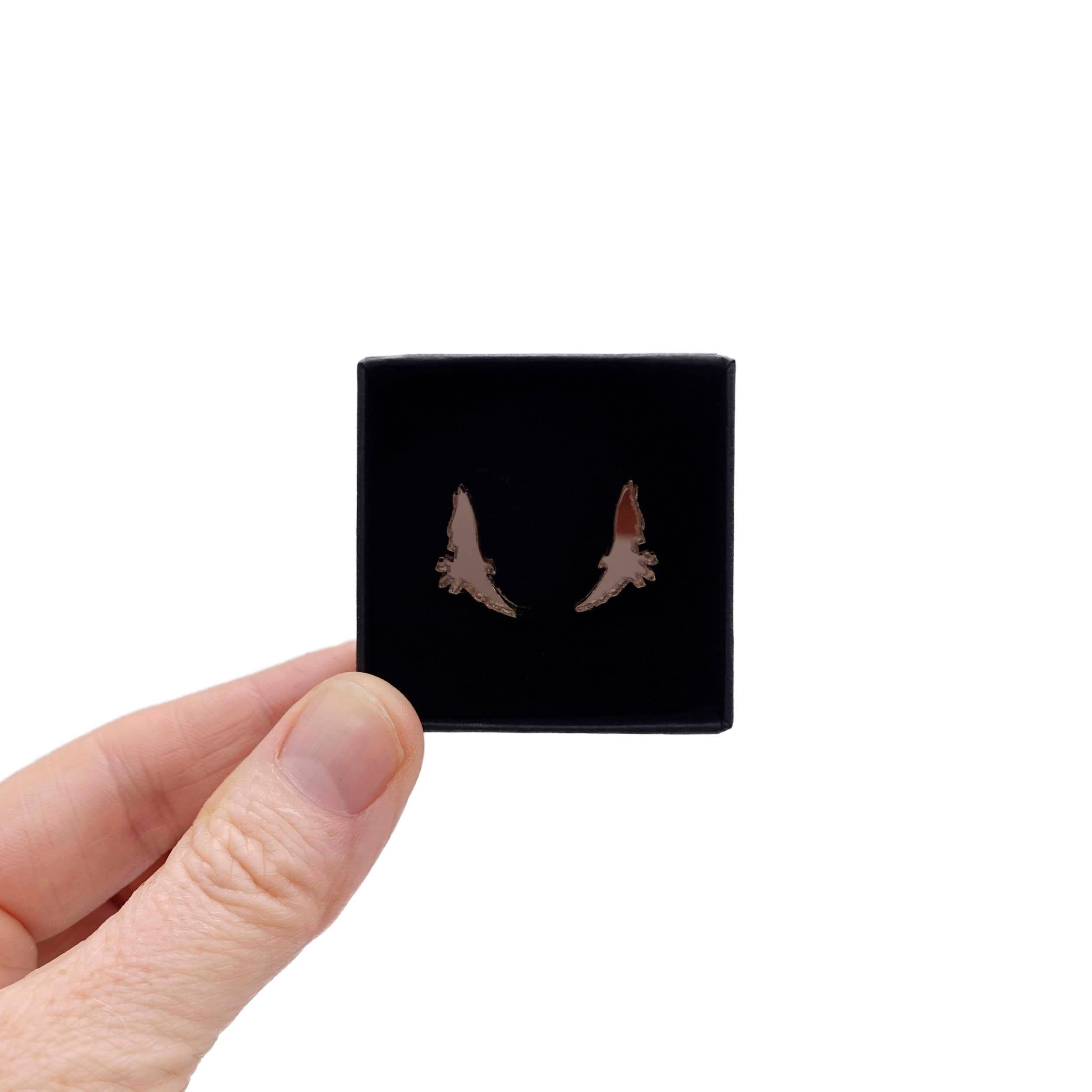 Bronze bird stud earrings that complement the jewellery in the the Brontë Collection, designed by Sarah Day in collaboration with the Brontë Parsonage Museum. Shown held up in a Wear and Resist gift box.