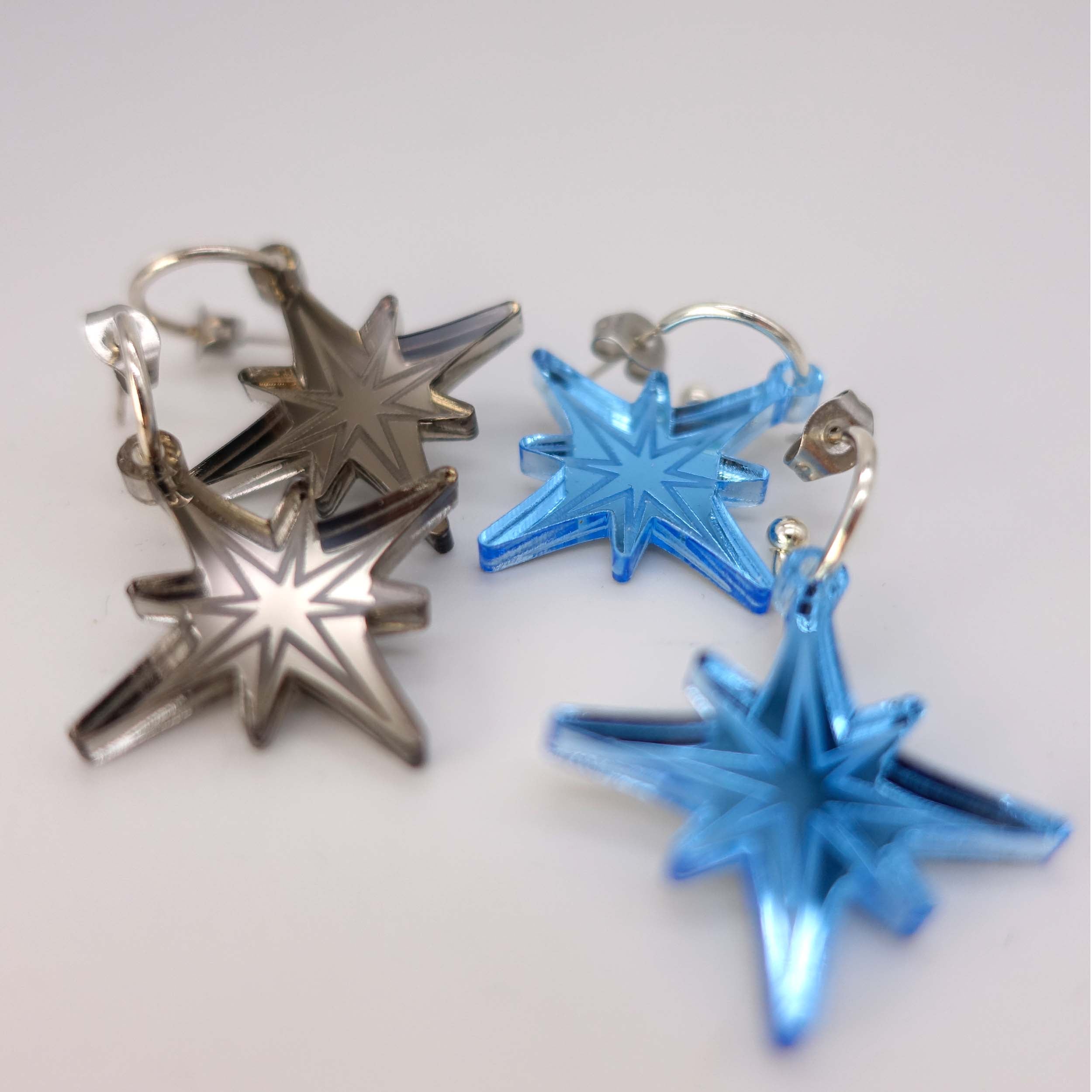 A close up of the sky and bronze etched vintage star earrings in bronze  mirror from the Bronte Collection.