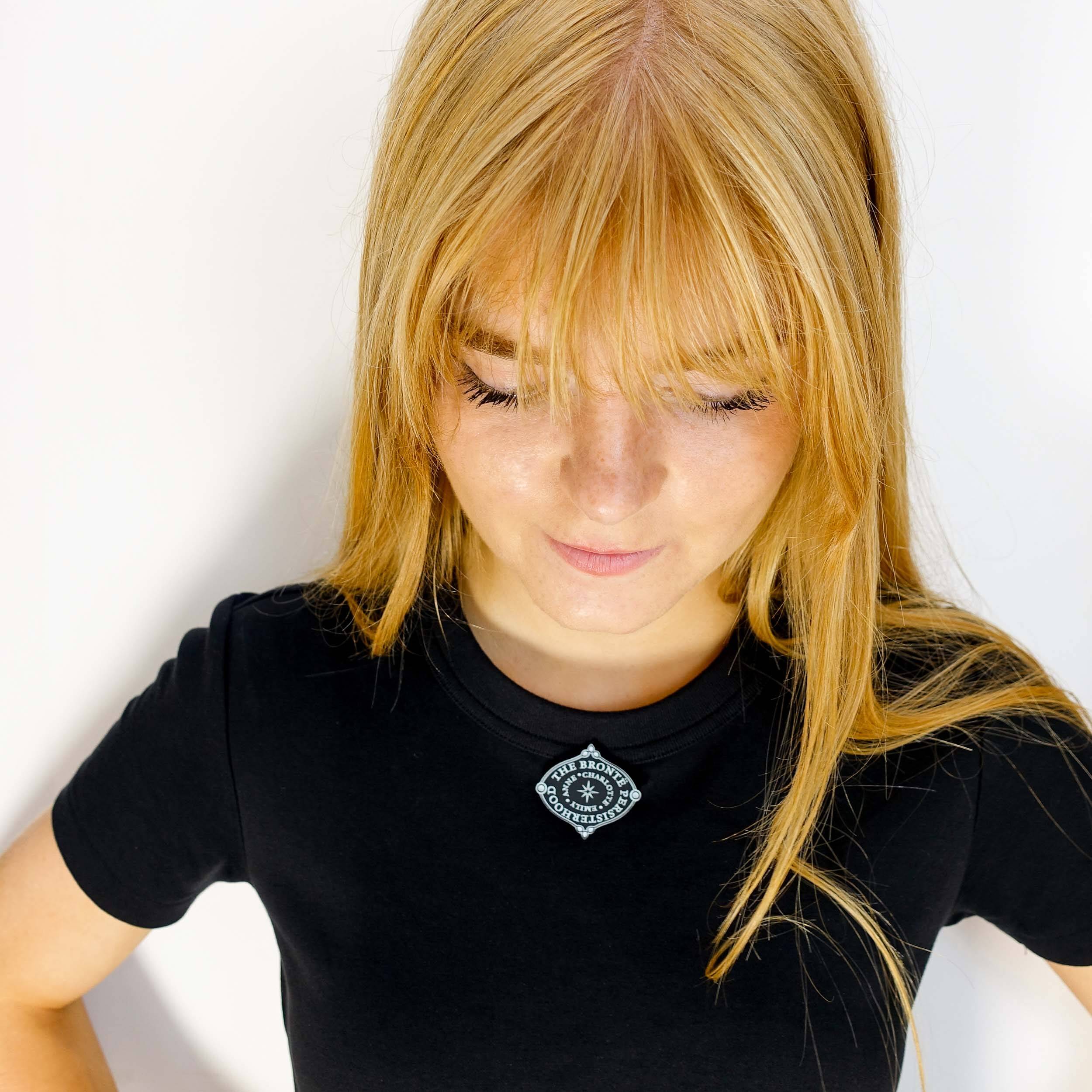 Eliza wears the Brontë Persisterhood brooch, designed by Sarah Day for Wear and Resist in collaboration with the Brontë Parsonage Museum.