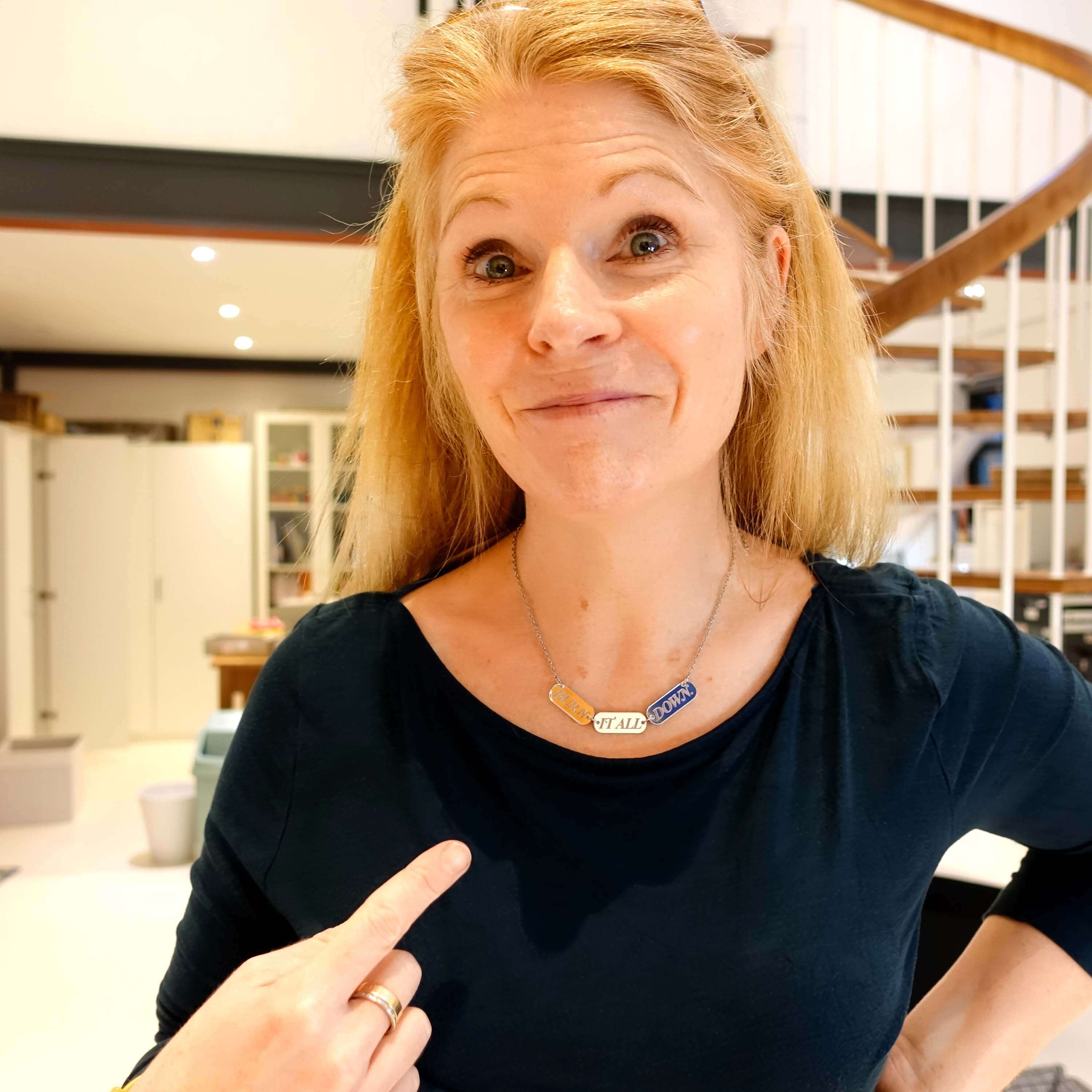 Sarah wears the BURN IT ALL DOWN necklace in silver mirror on a stainless steel chain.