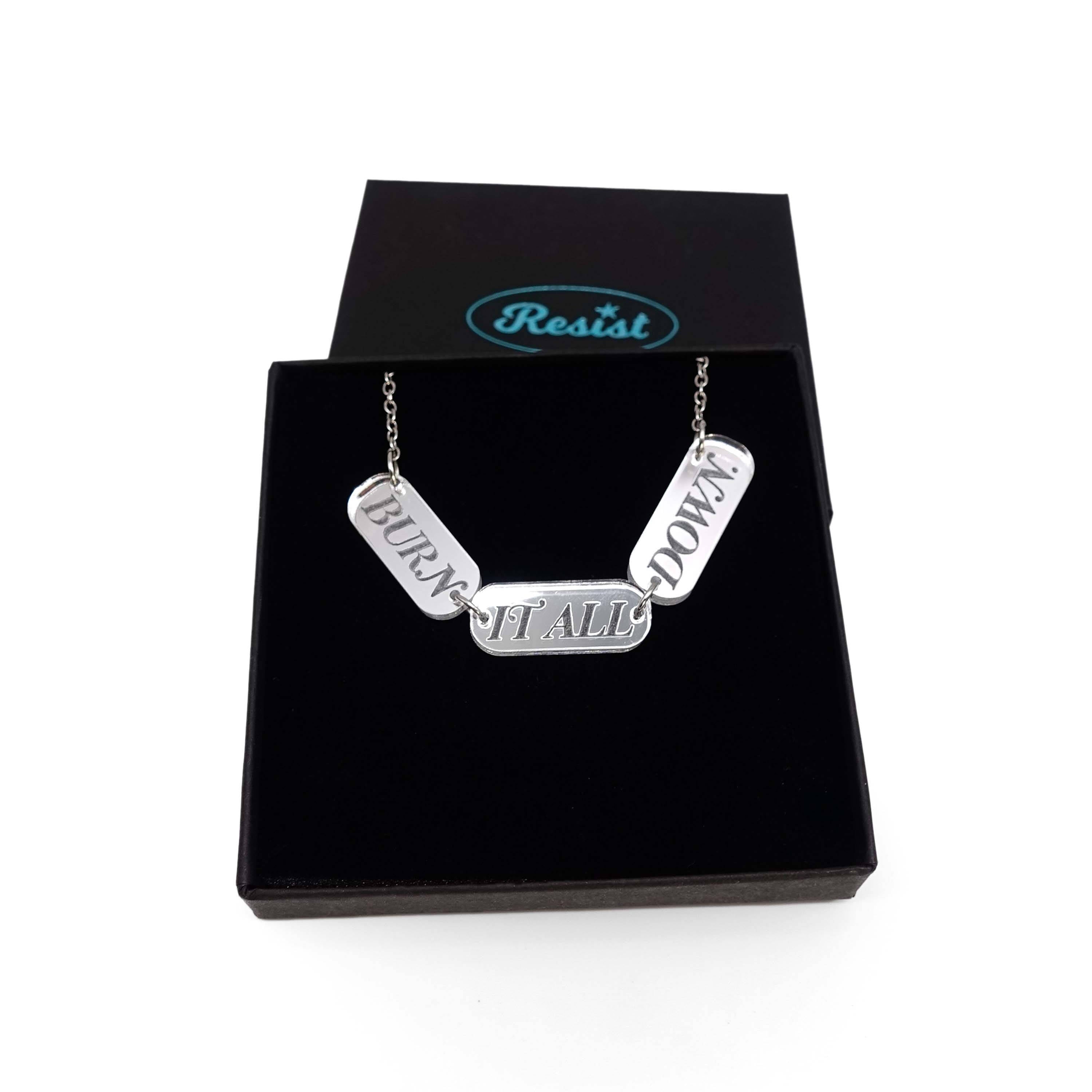 BURN IT ALL DOWN necklace in silver mirror on a stainless steel chain, shown in a Wear and Resist gift box.
