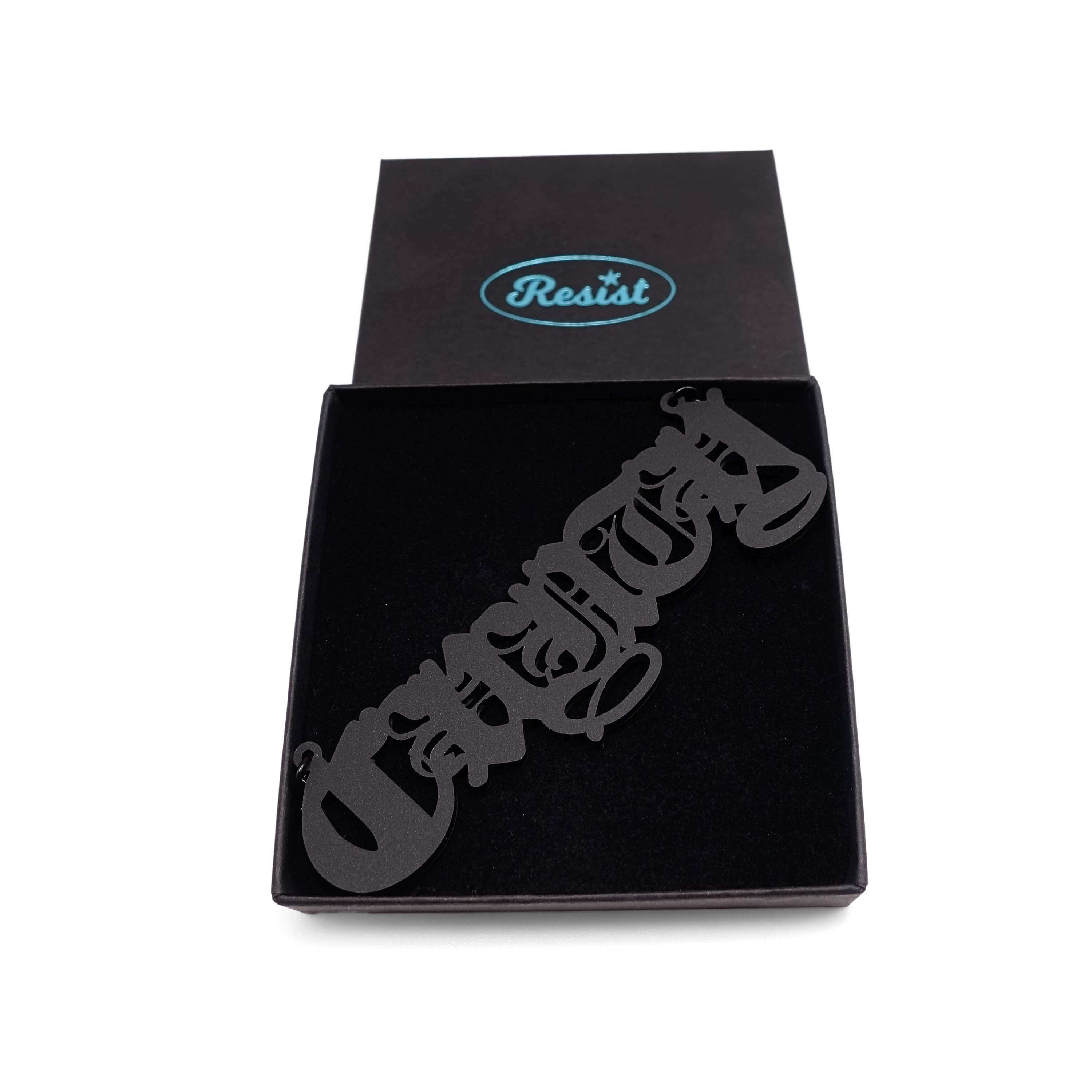 Big C*nty necklace in matte black, shown in a Wear & Resist gift box.