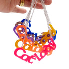 All of the different colour Cat Lady necklaces, shown held up in a bunch against a white background.