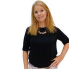 Sarah Day, founder of Wear and Resist wears a pink fizz glitter Cat Lady necklace.