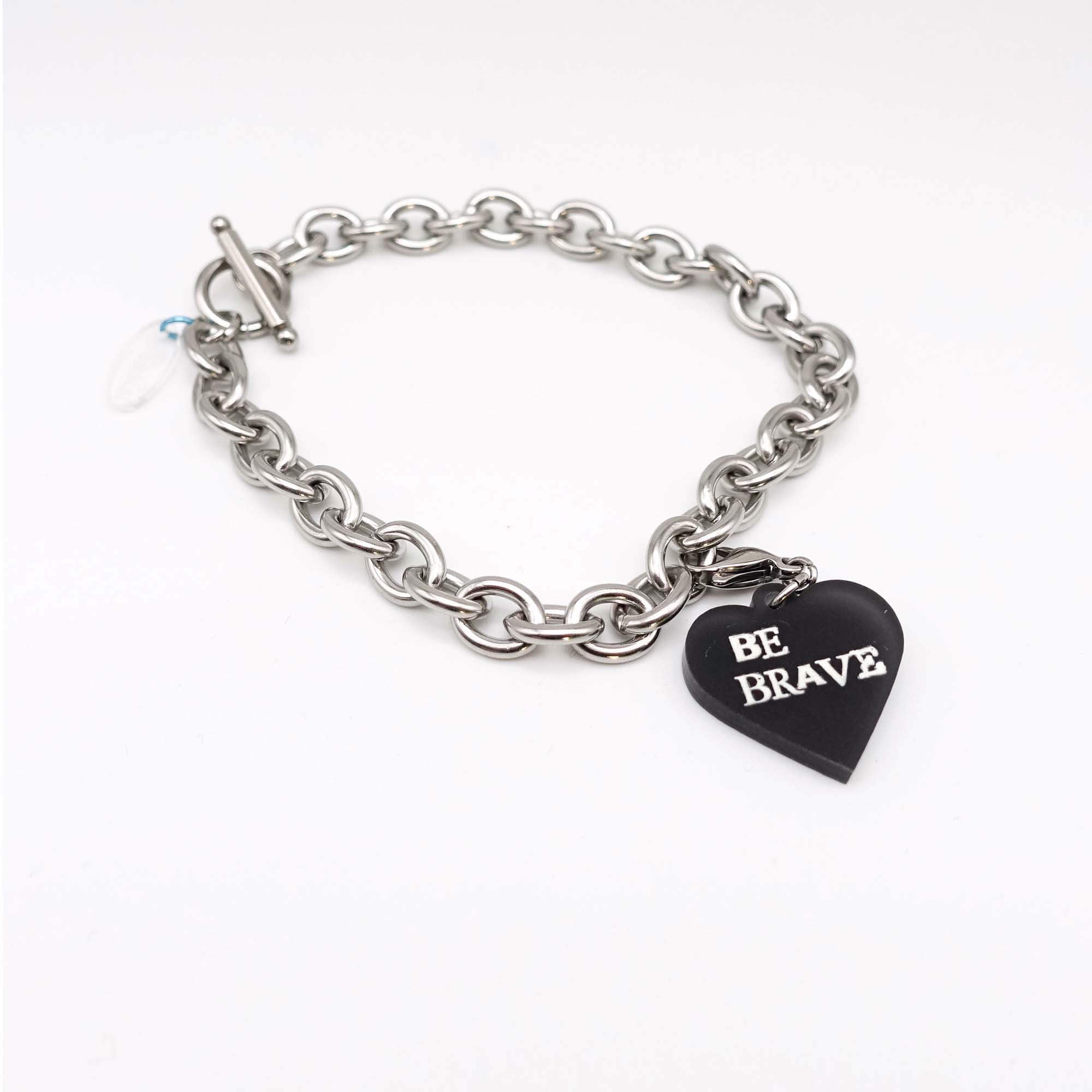 Stainless steel charm bracelet with slate Be Brave glow-in-the-dark heart charm.