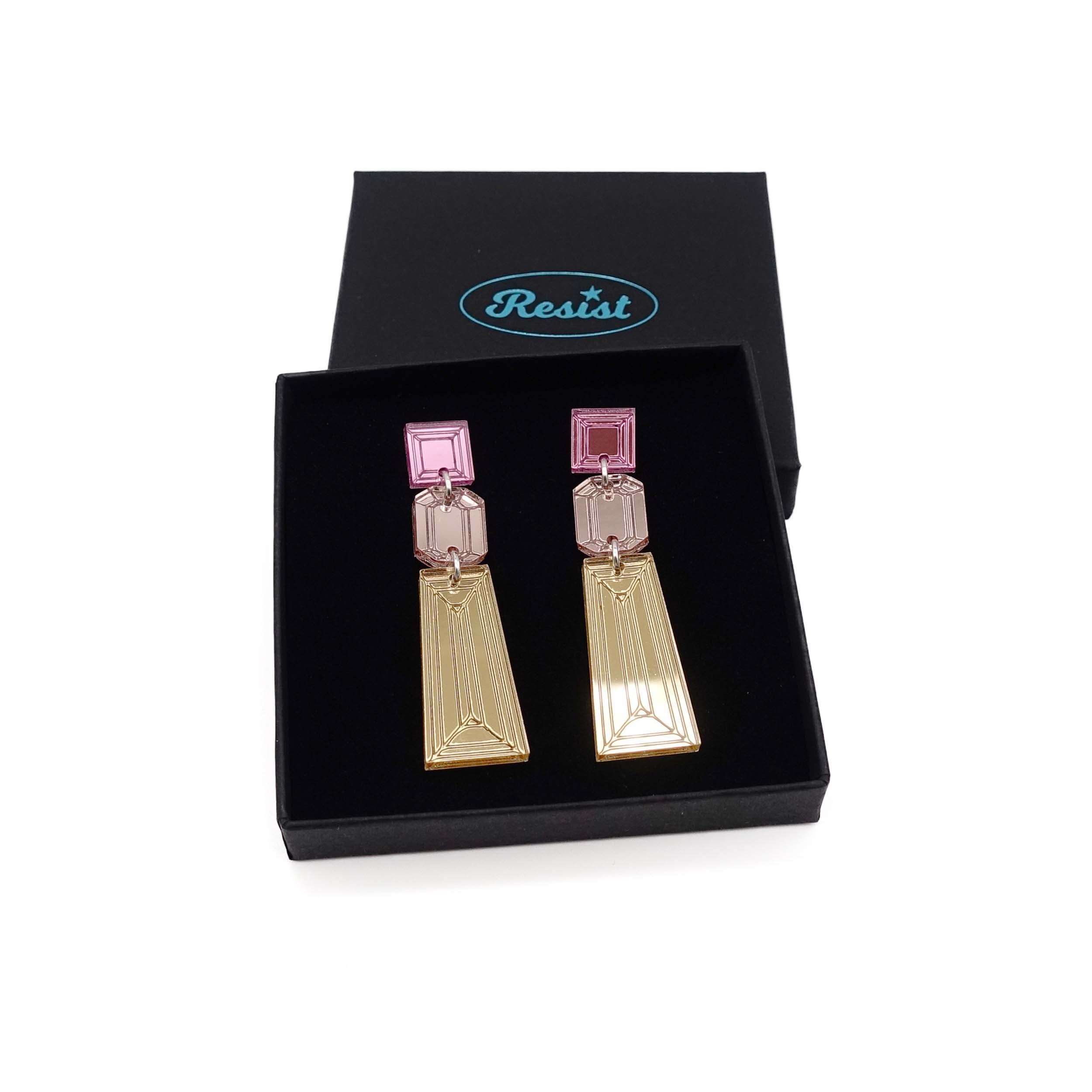 Long Deco drop earrings in gold, rose gold and pink mirror shown in a Wear and Resist gift box.