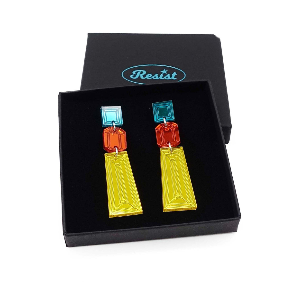 Long Deco drop earrings in yellow, flame and teal shown in a Wear and Resist gift box.