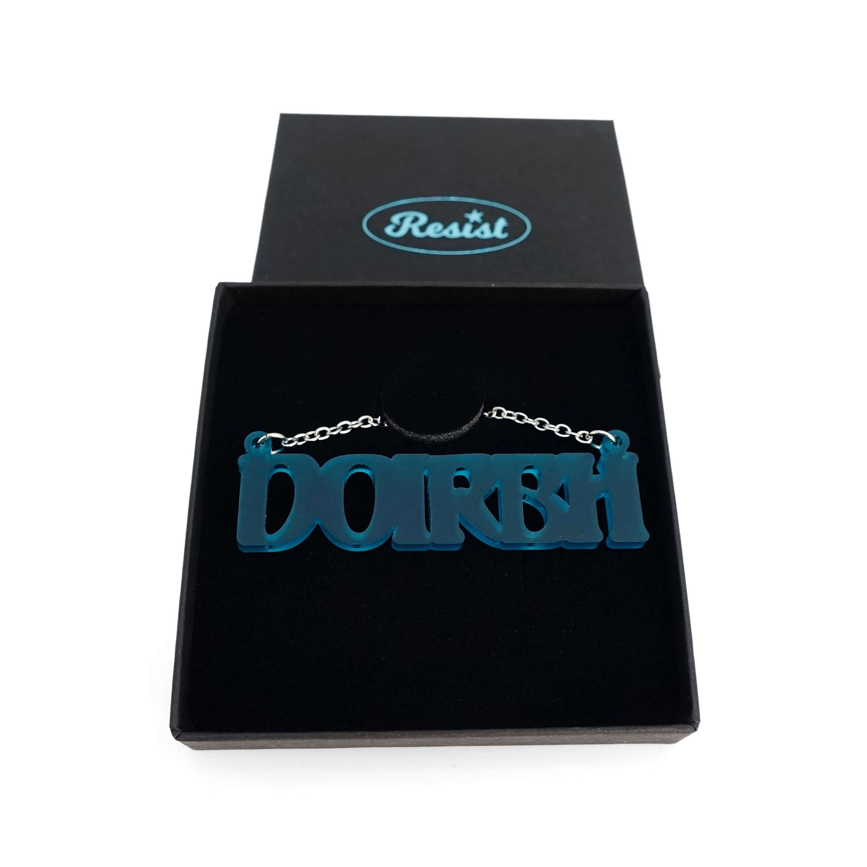 DOIRBH Gaelige necklace for Irish difficult women in teal frost, shown in a Wear & Resist gift box.