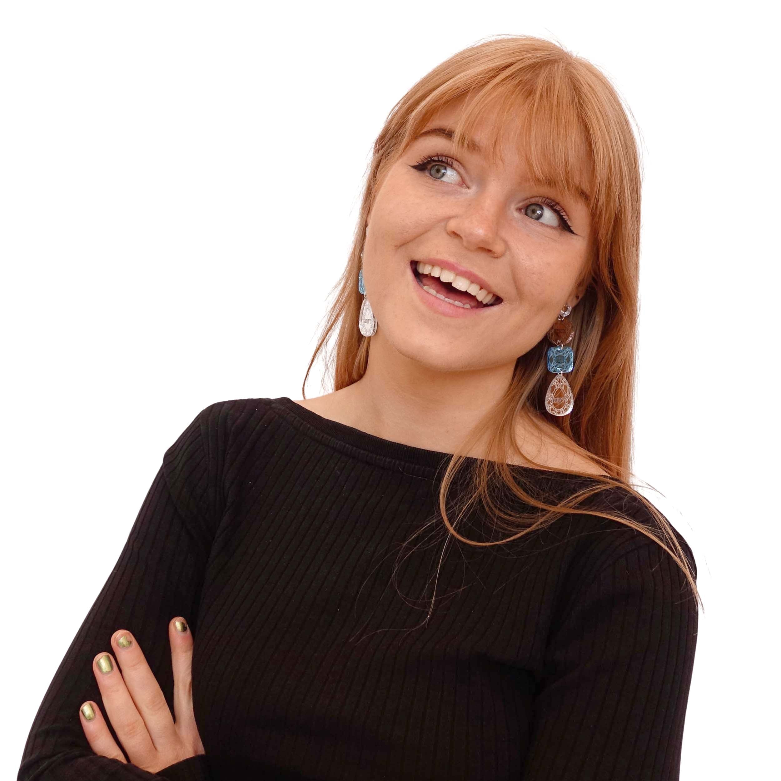 Eliza wears F*ck this Sh*t  Jewel earrings in blue and bronze.