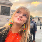 Eliza wears Flame Mambo Festive Drop statement earrings.