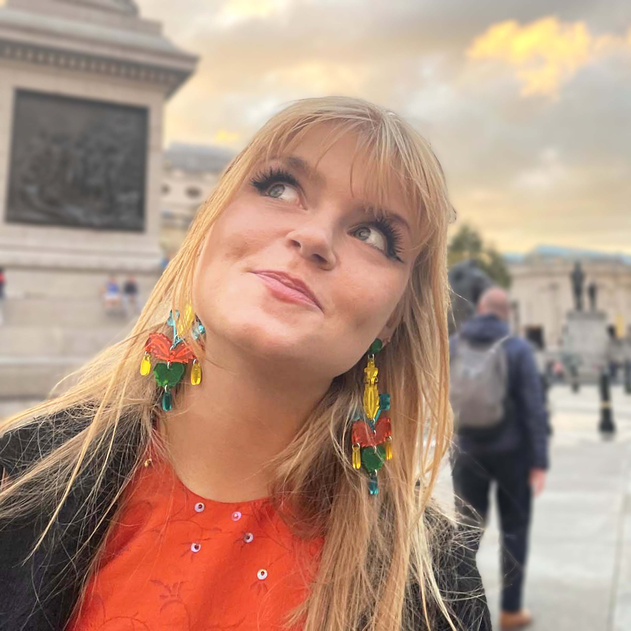 Eliza wears Flame Mambo Festive Drop statement earrings.