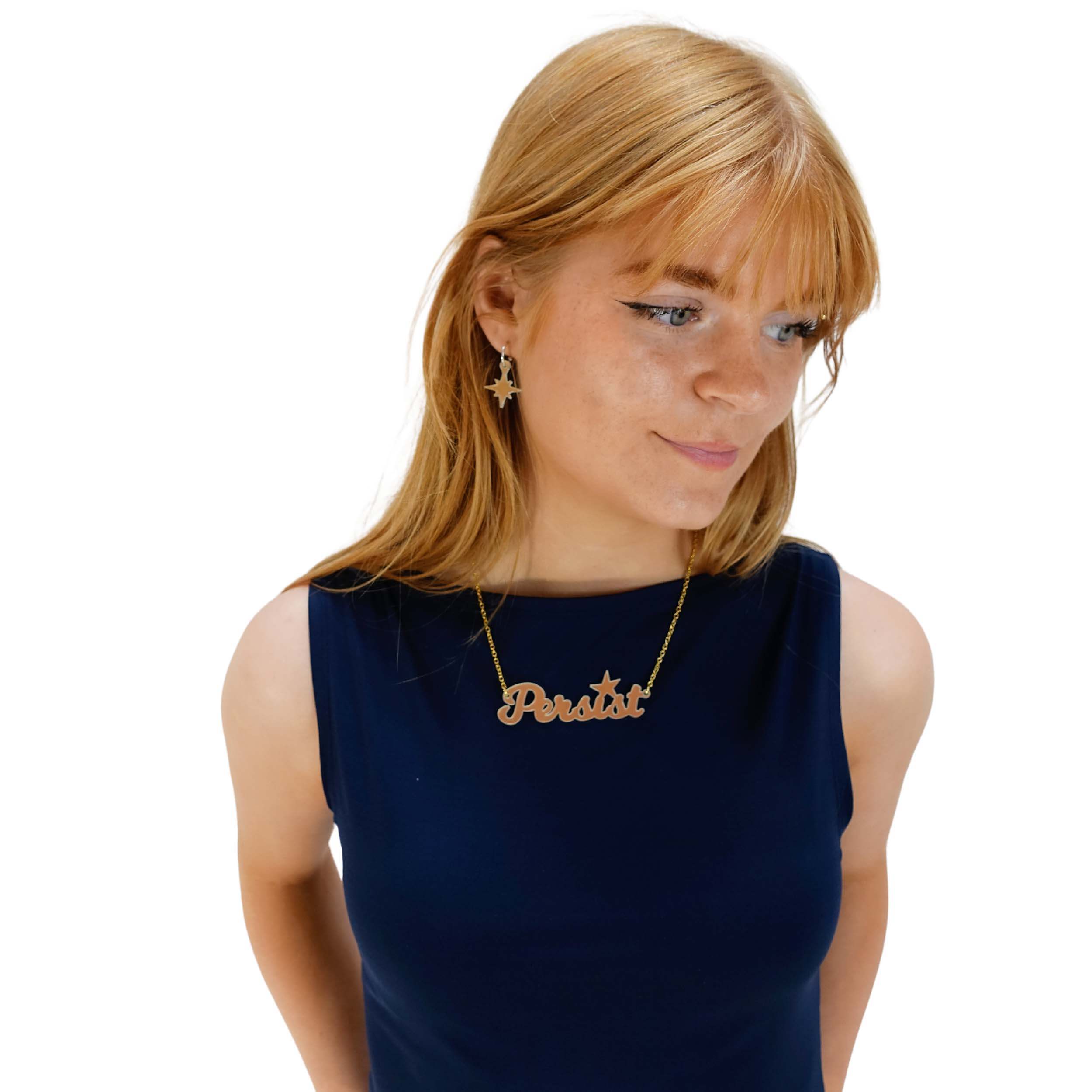 Eliza wears a matte iridescent Persist necklace.