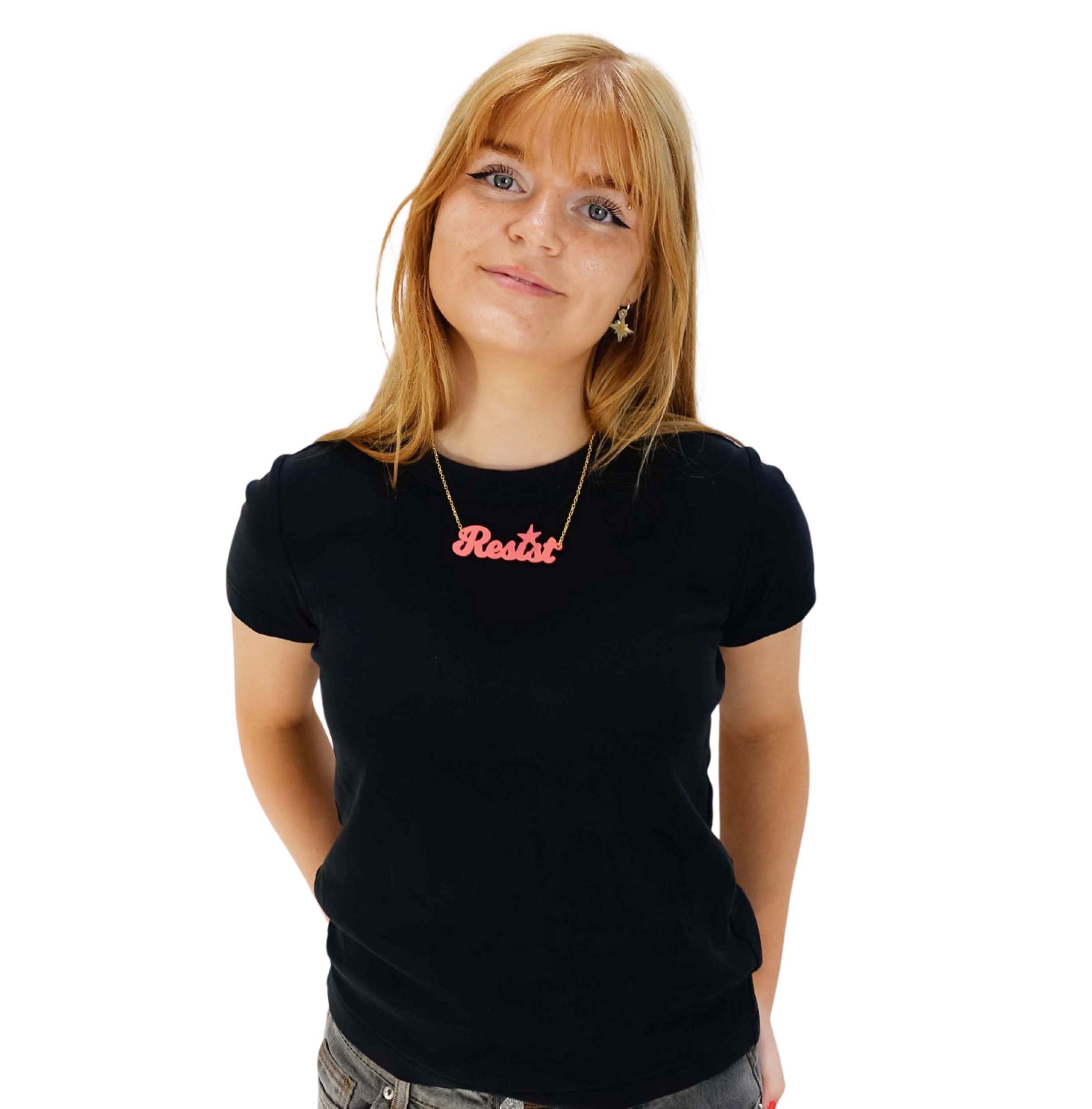 Eliza wears a sunset pink Resist necklace.