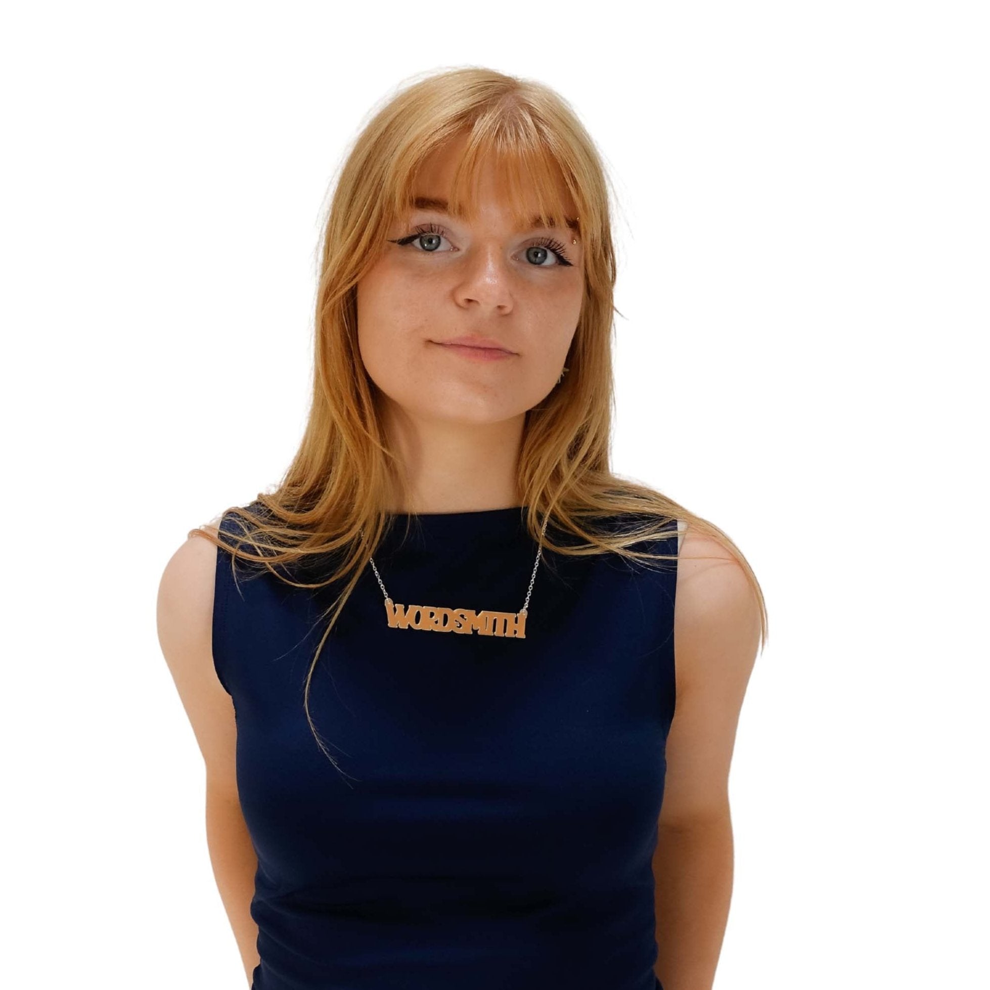 Eliza wears a Wordsmith necklace in matte iridescent.