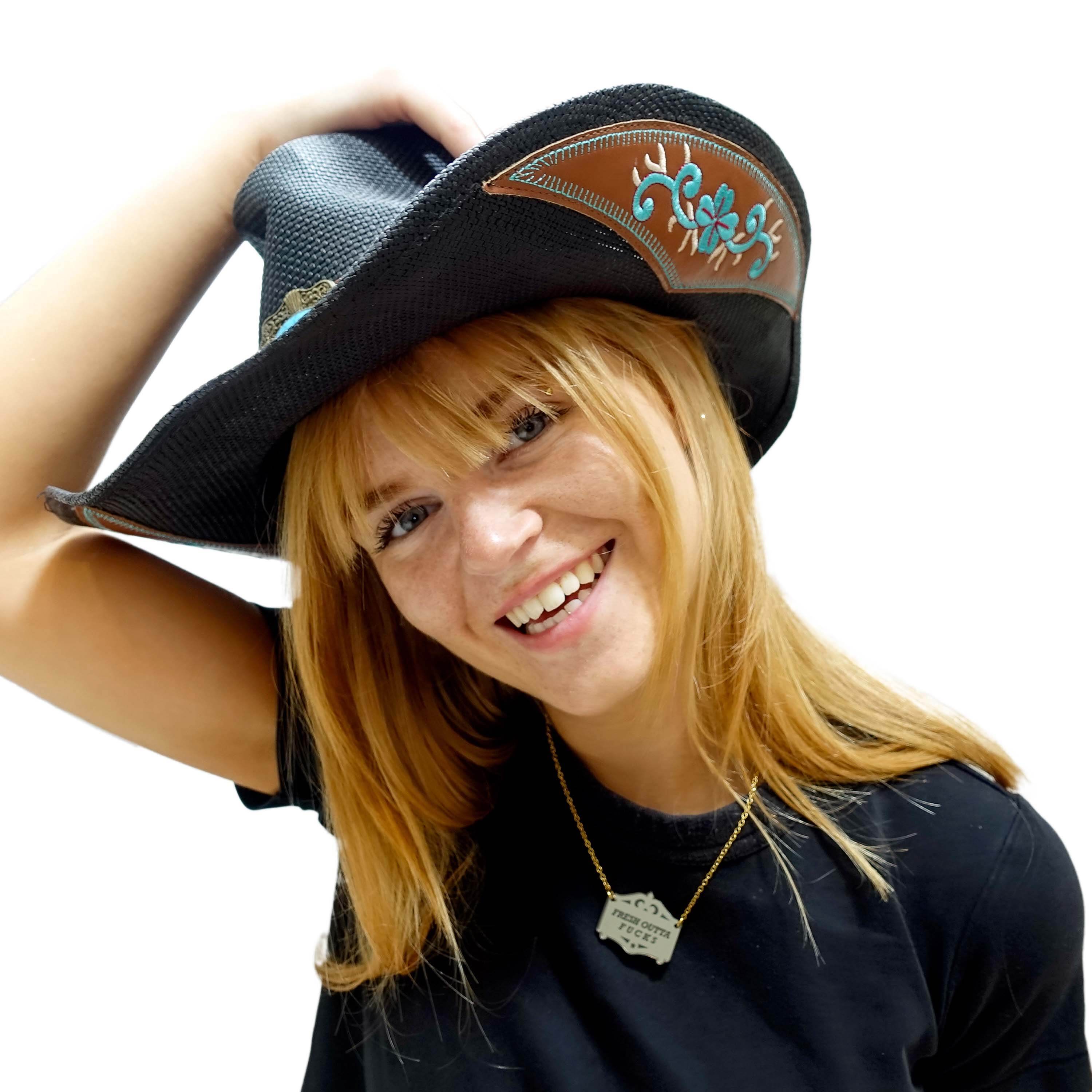 Eliza wears a bronze Fresh outta f*cks mirror cowboy necklace on a gold-plated stainless steel chain.