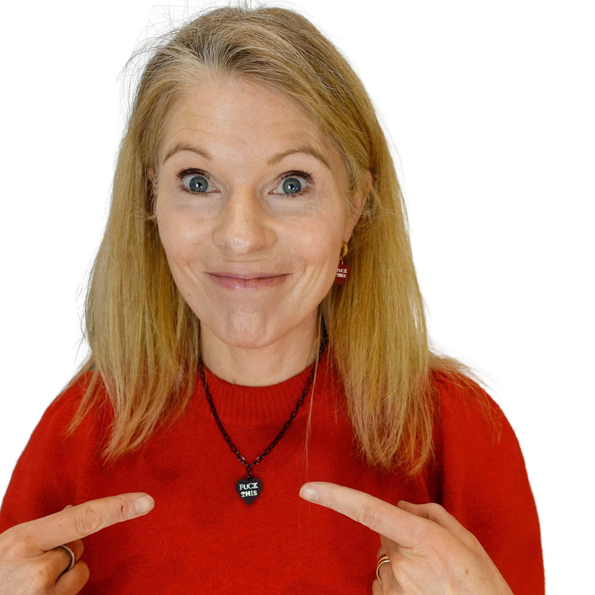 Sarah wears a F*ck This heart necklace in slate on a black chain.