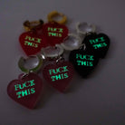 F*ck This huggie hoop earrings shown glowing in the dark. You can recharge them with your phone and they gold their glow!