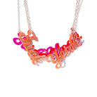 All of the F*ck Yeah necklaces hanging in a bunch to show the different colours.