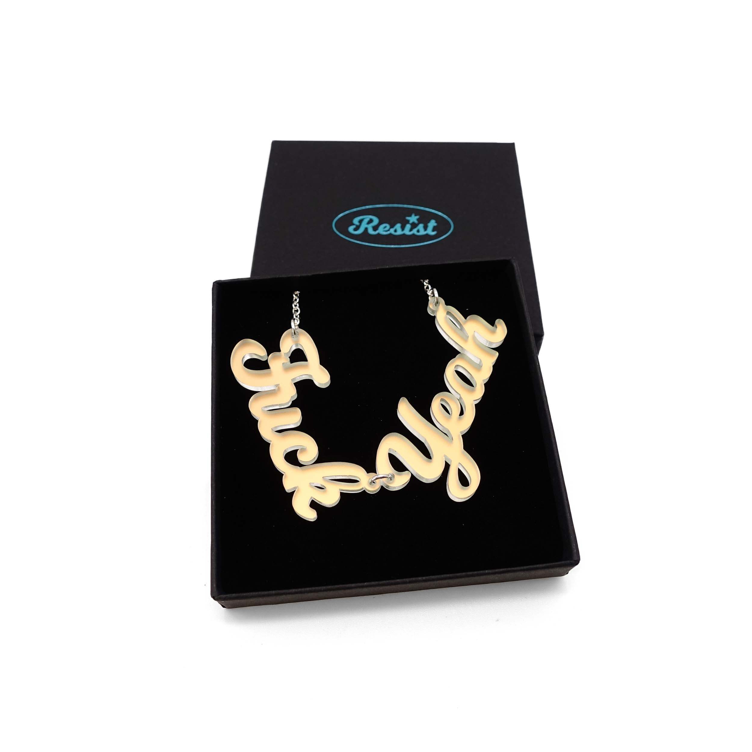 F*ck Yeah necklace in matte iridescent, shown in a Wear and Resist gift box.
