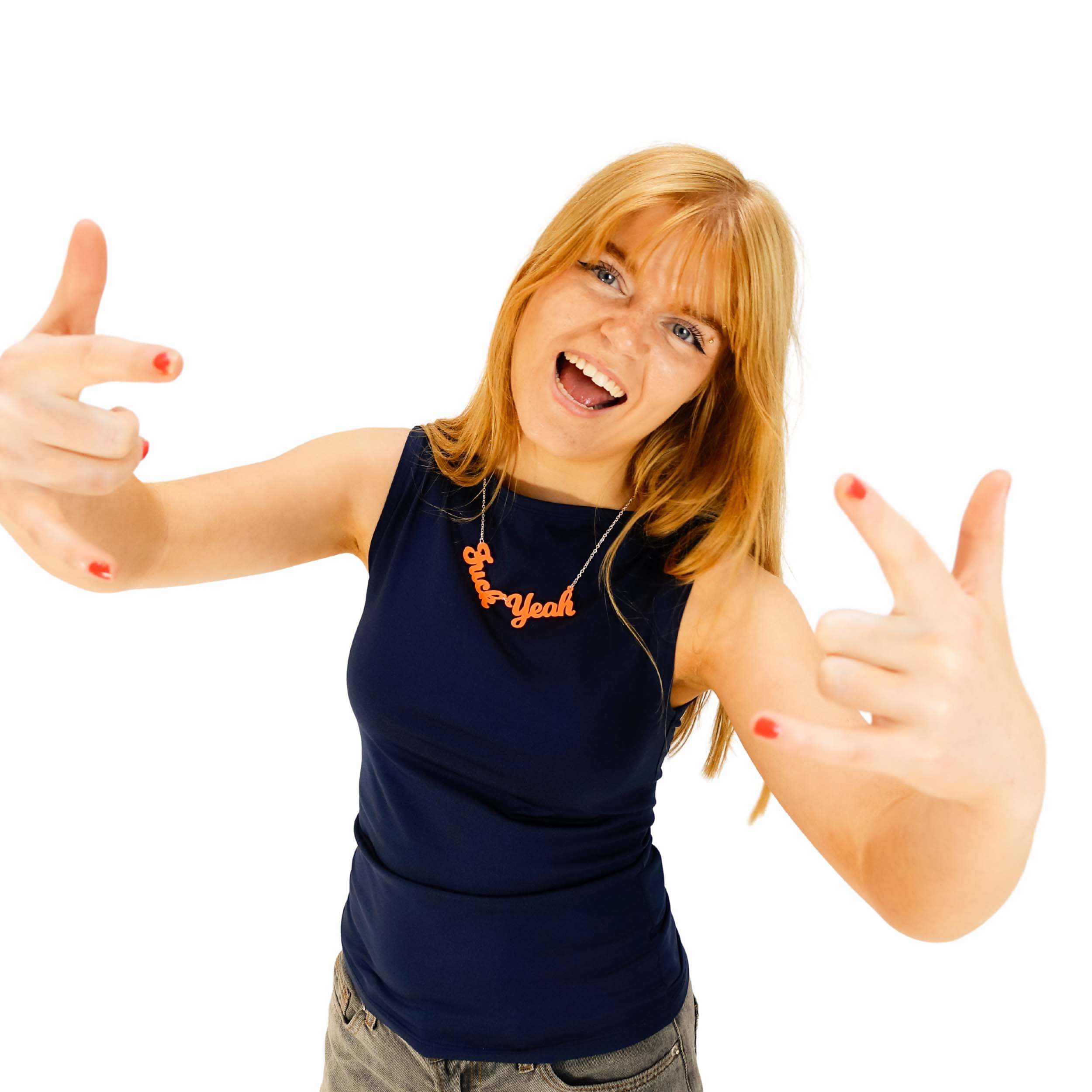 Eliza wears a F*ck Yeah necklace in day-glo orange.