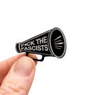 F*ck the Fascists megaphone brooch, shown held up in my fingers for size reference.