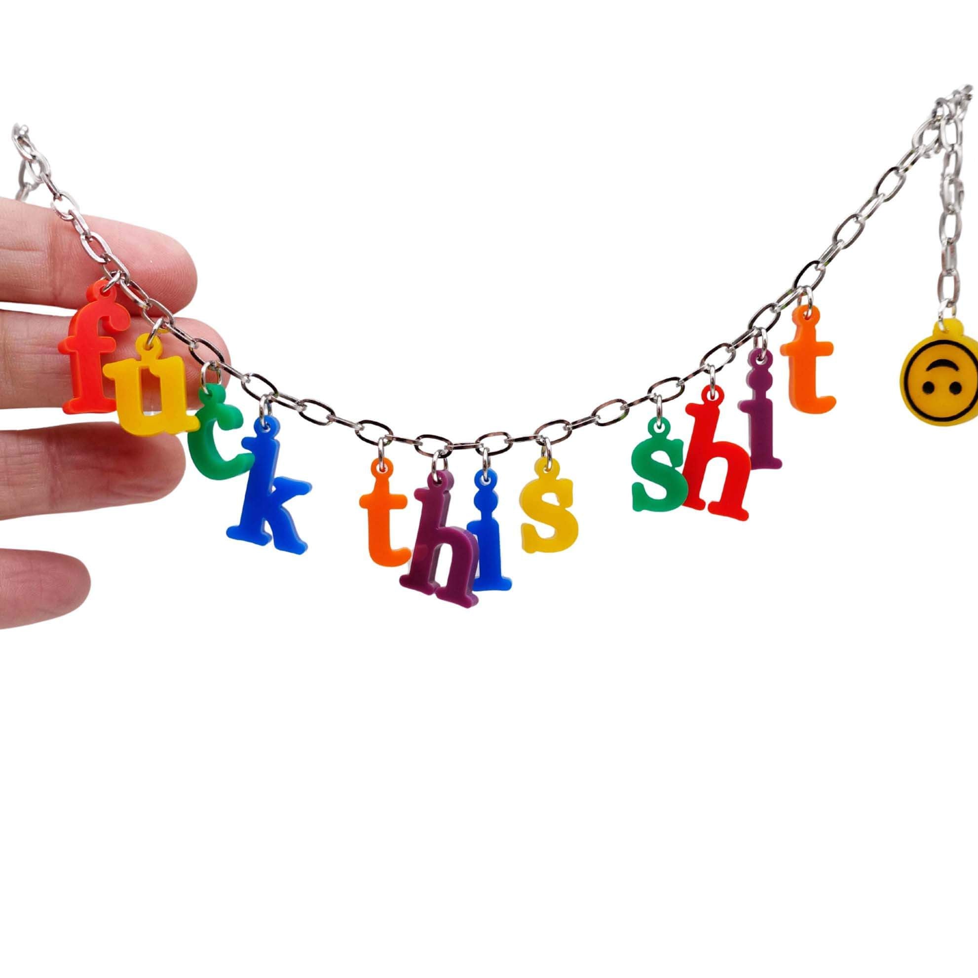 F*ck this Sh*t Alphabet necklace with colourful sweary letters and an upside down smiley face emoji shown hanging against a white background.