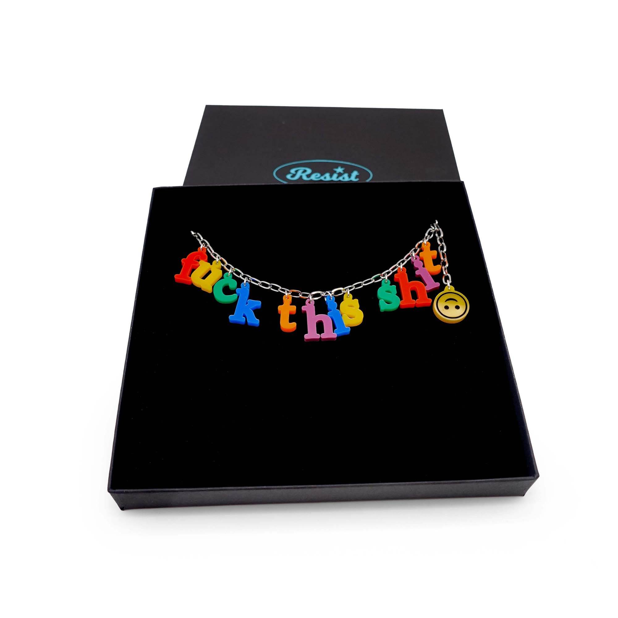F*ck this Sh*t Alphabet necklace with colourful sweary letters and an upside down smiley face emoji! shown in a large Wear and Resist gift box. Designed by Sarah Day for Wear and Resist.