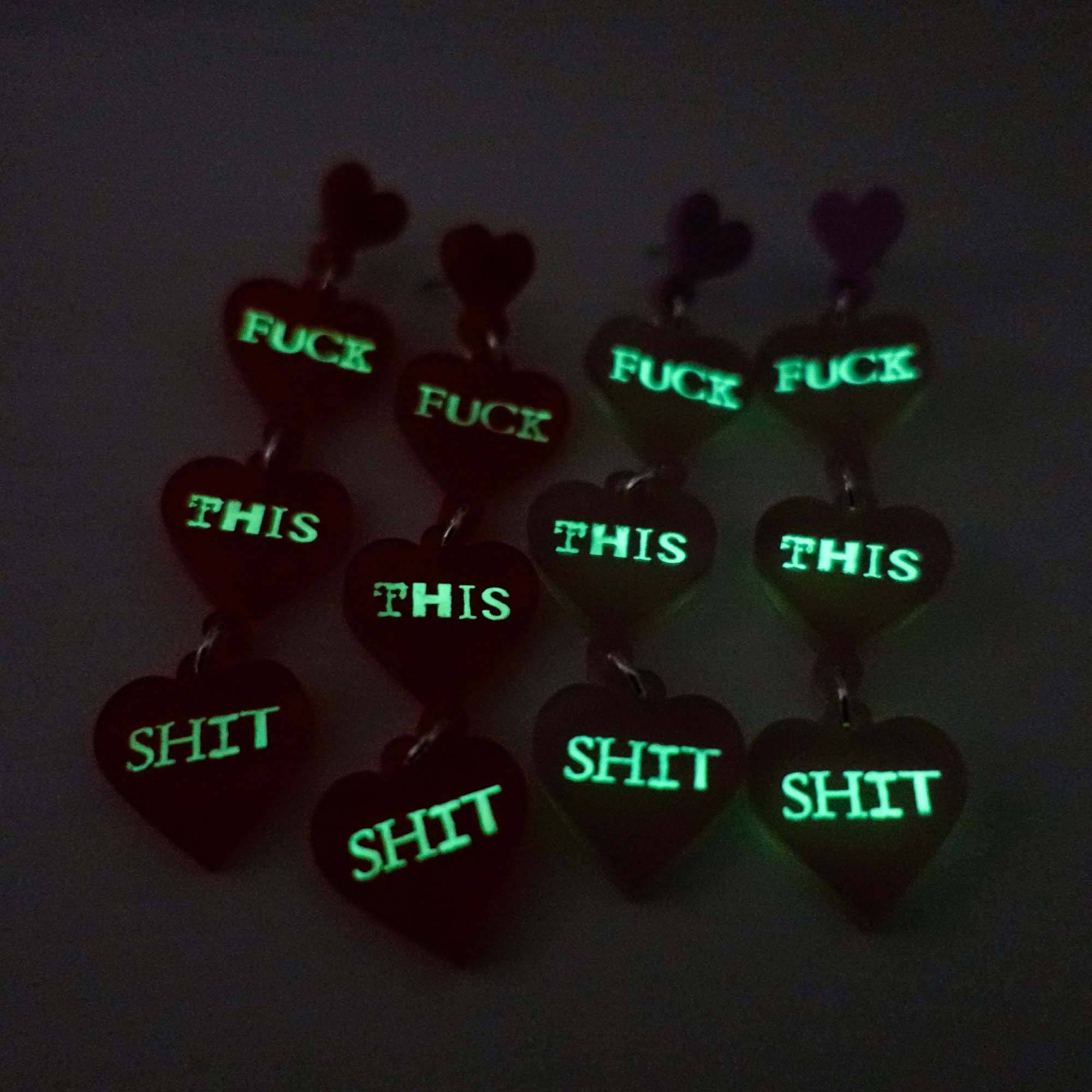 F*ck this Sh*t earrings glowing in the dark. £2 goes to Bloody Good Period.