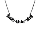 F*ck this Sh*t necklace in matte black shown hanging on a black chain against a white background.
