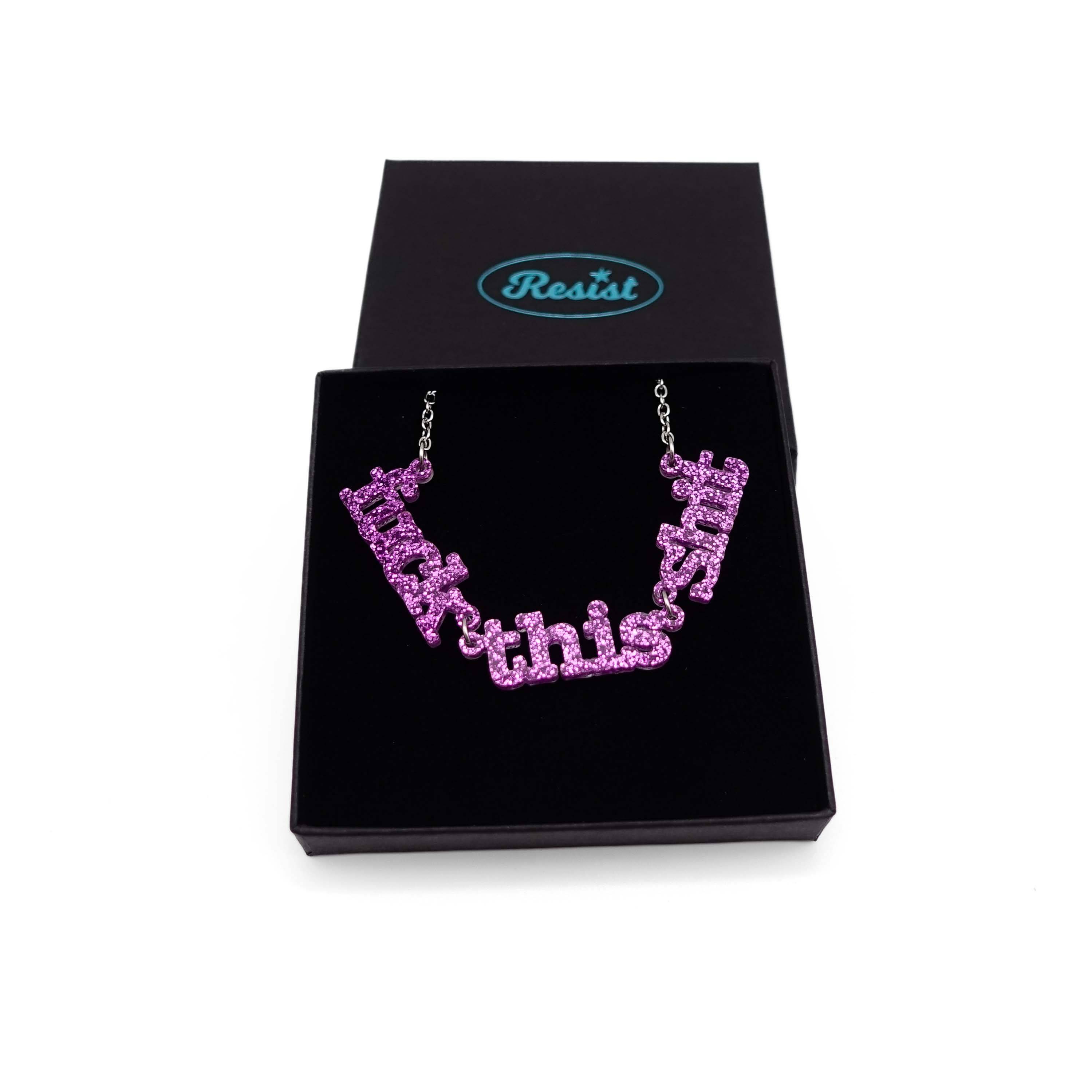 F*ck this Sh*t necklace in purple glitter shown in a Wear and Resist gift box.