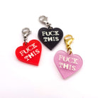 Heart charms in chilli frost, pink frost and slate frost etched in glow-in-the-dark pigment with the words 'F*ck This'