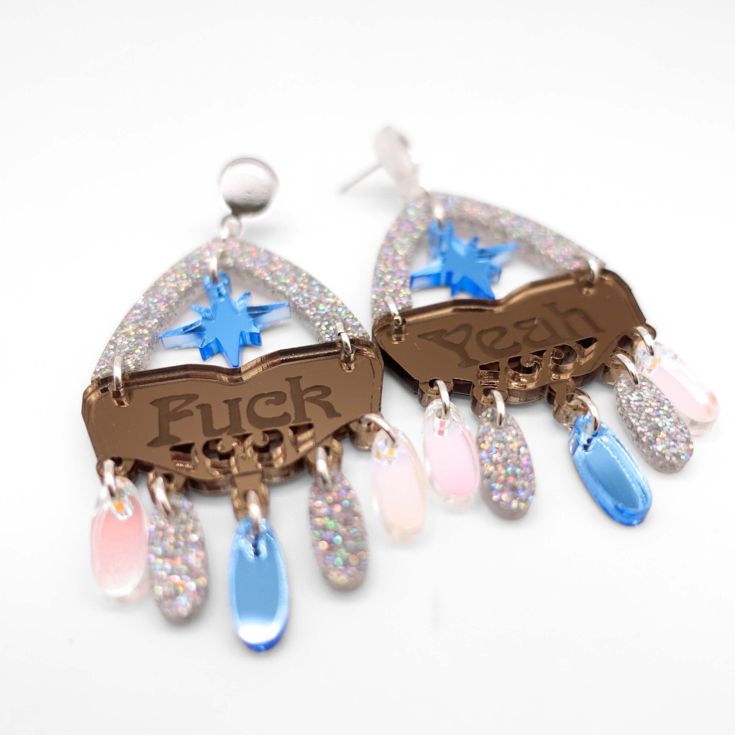 A close up of the F*ck Yeah statement earrings in sky cowgirl colourway.