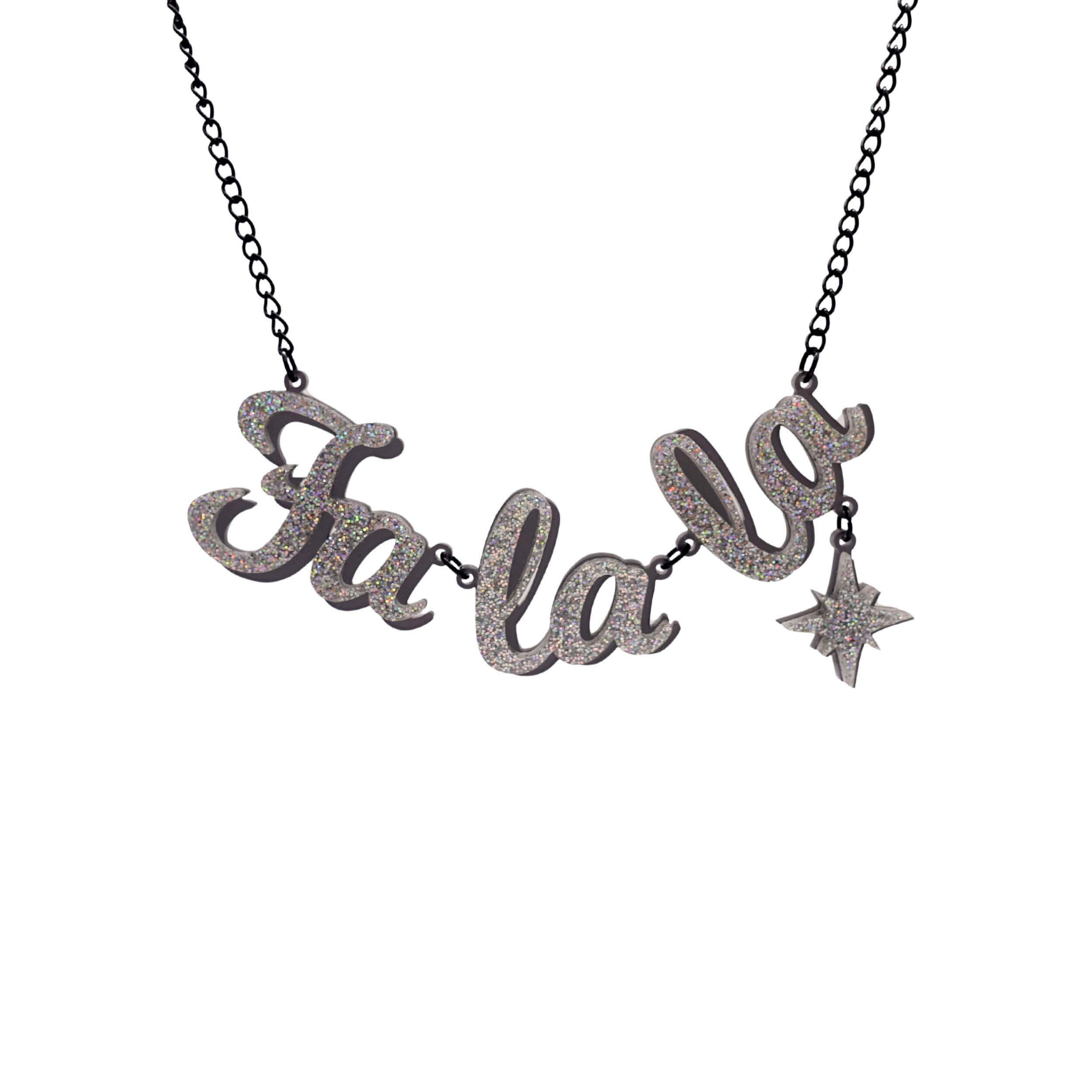 Fa La LA necklace in silver glitter, with hanging vintage star, shown hanging against a white background. Designed by Sarah Day for the Christmas Collection.