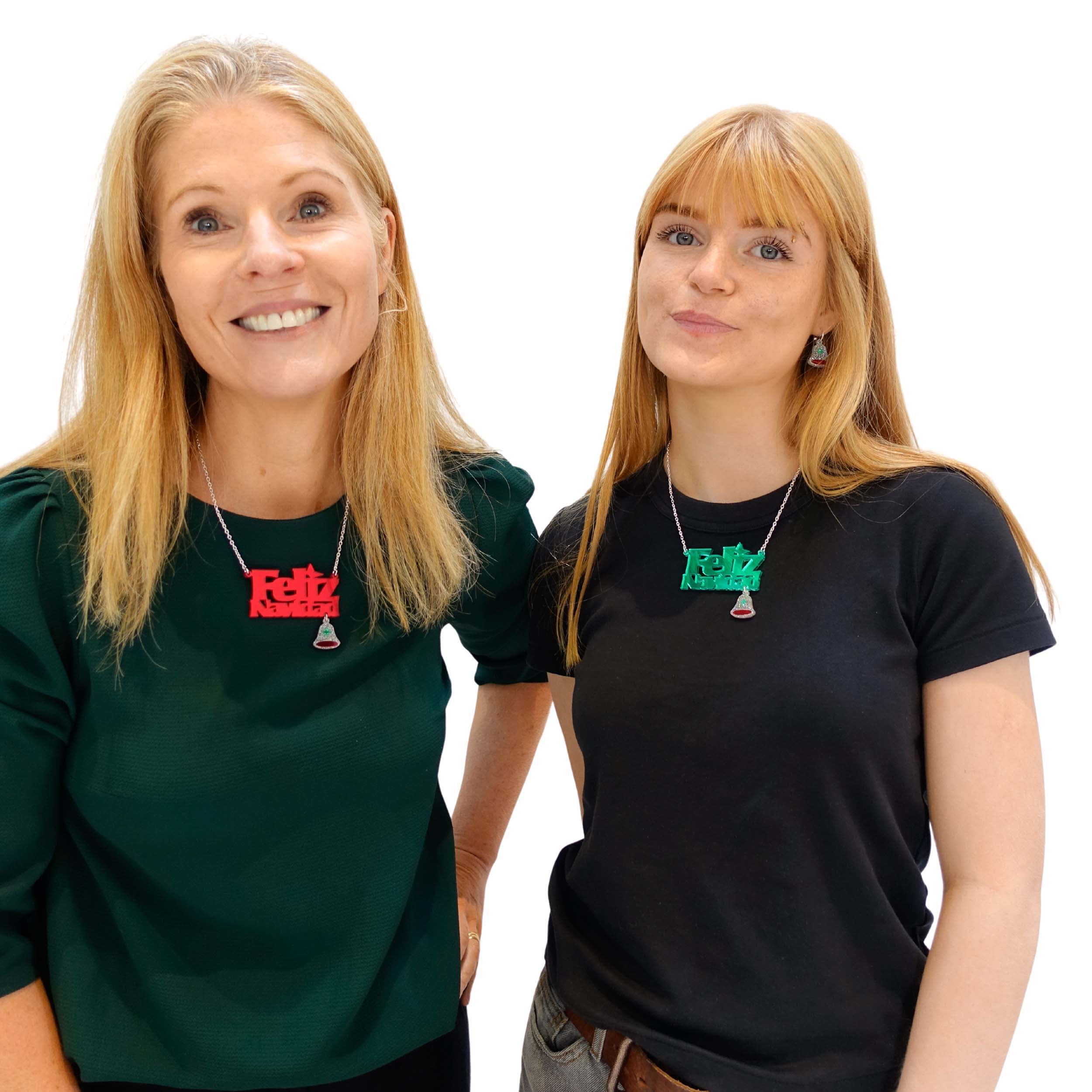 Sarah Day, founder of Wear and Resist with her daughter, Eliza, both wearing Feliz Navidad necklaces in electric green and ruby red.