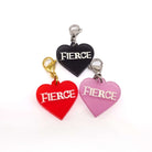 Heart charms in chilli frost, pink frost and slate frost etched in glow-in-the-dark pigment with the word 'Fierce'