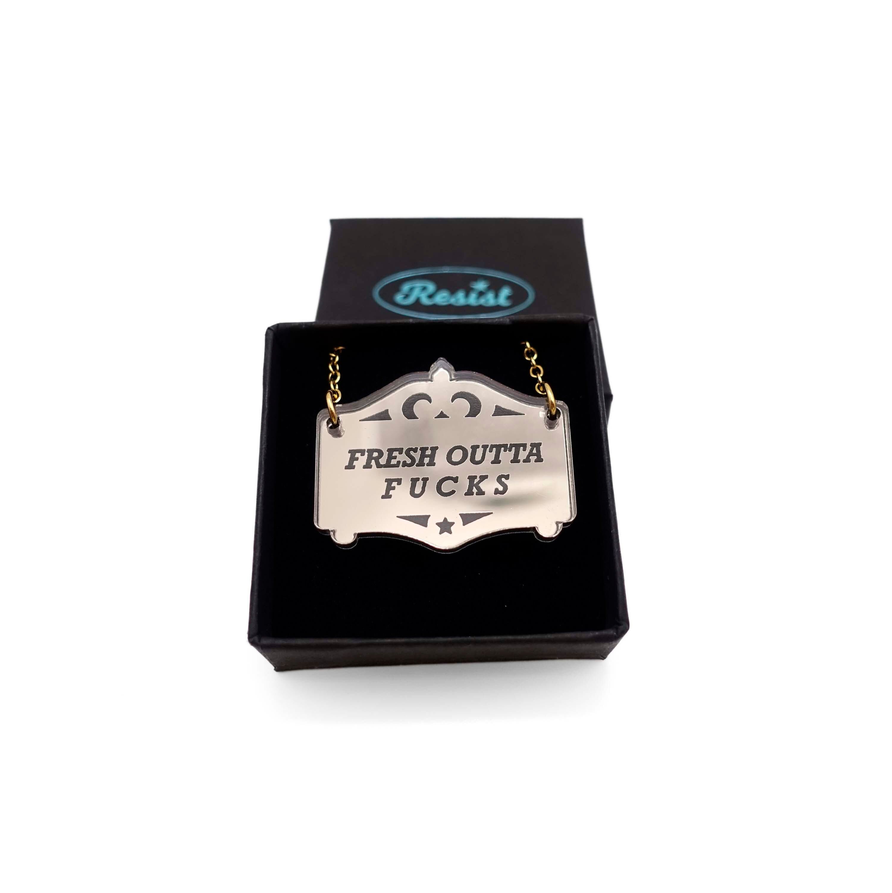 Fresh outta f*cks mirror cowboy necklace in bronze, shown in a small Wear and Resist gift box.