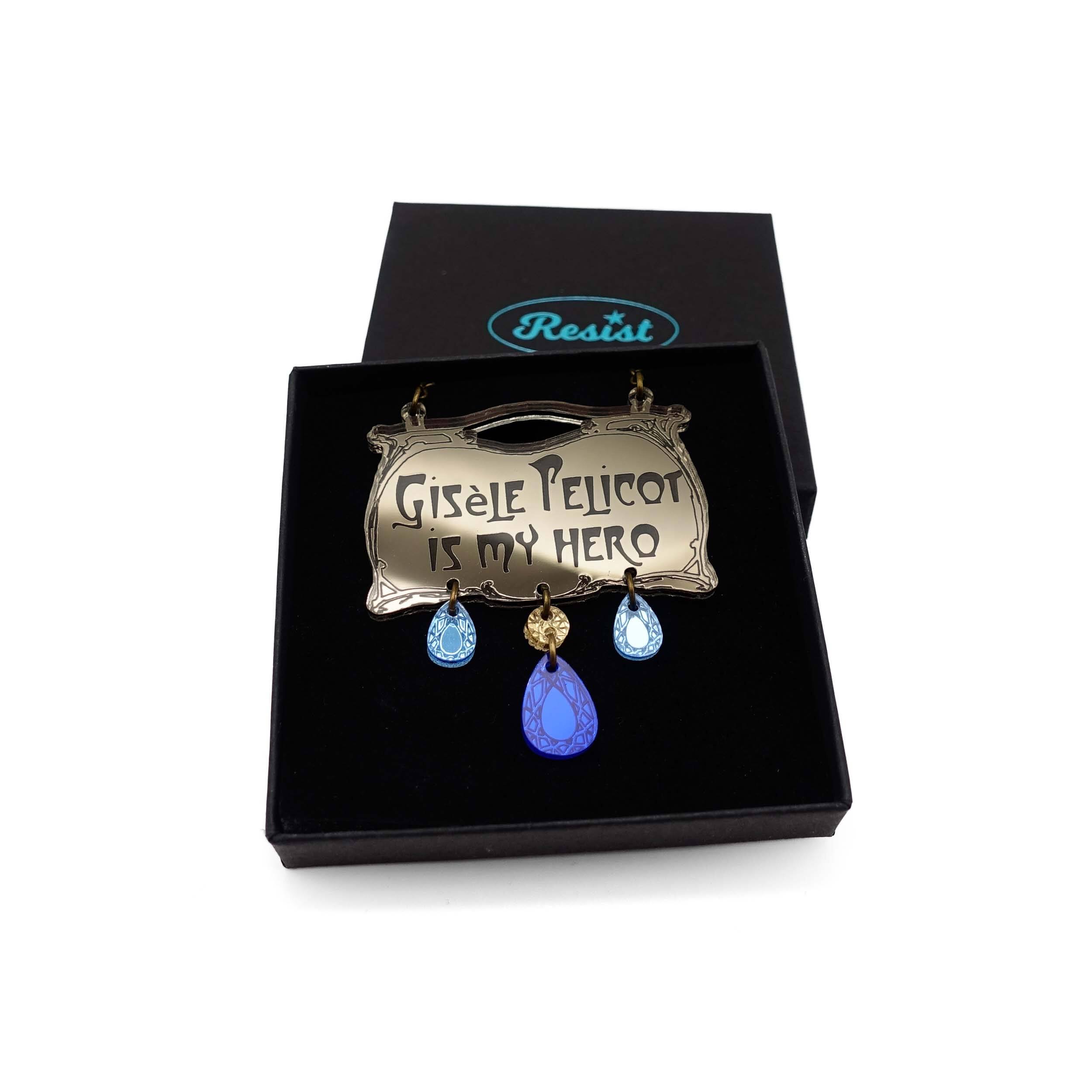 Bronze necklace in Paris Metro Hector Guimard style with etched writing 'Gisele Pelicot is my hero' with dangling acrylic jewels in sky and electric blue.