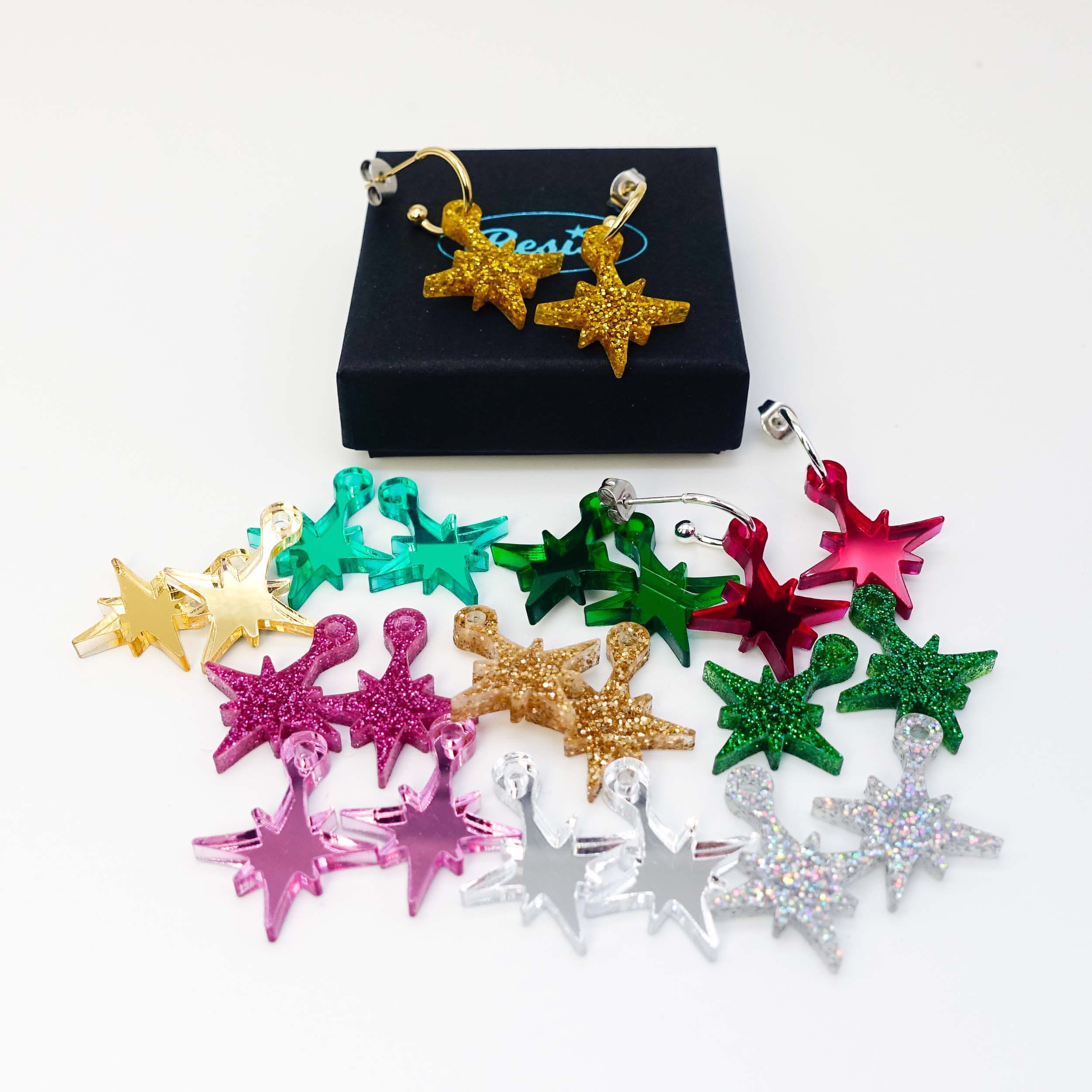 Festive Vintage Star earrings shown together in front of a Wear and Resist gift box.