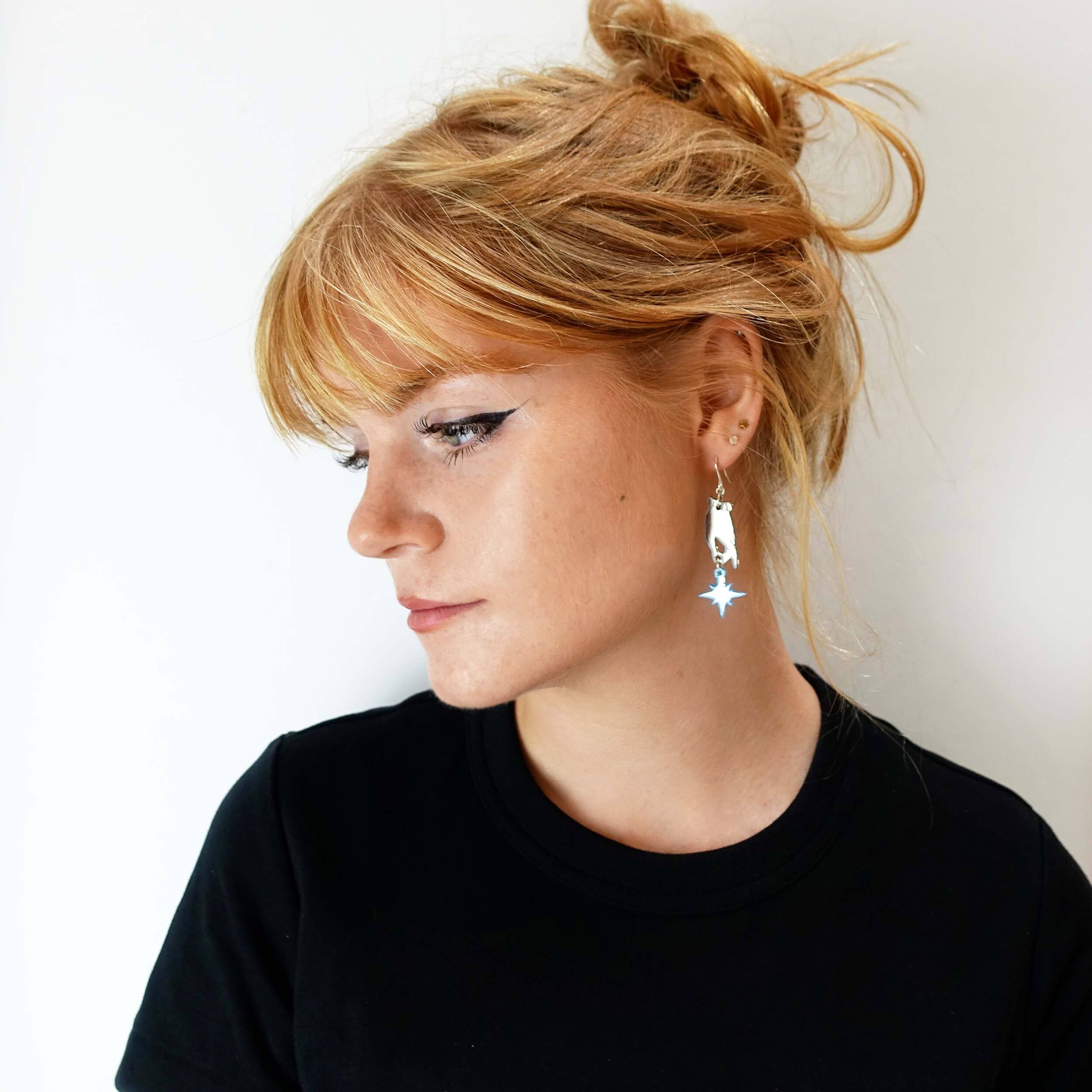 Eliza wears Dreams and Stars earrings from the Brontë Collection, designed by Sarah Day in collaboration with the Brontë Parsonage Museum.