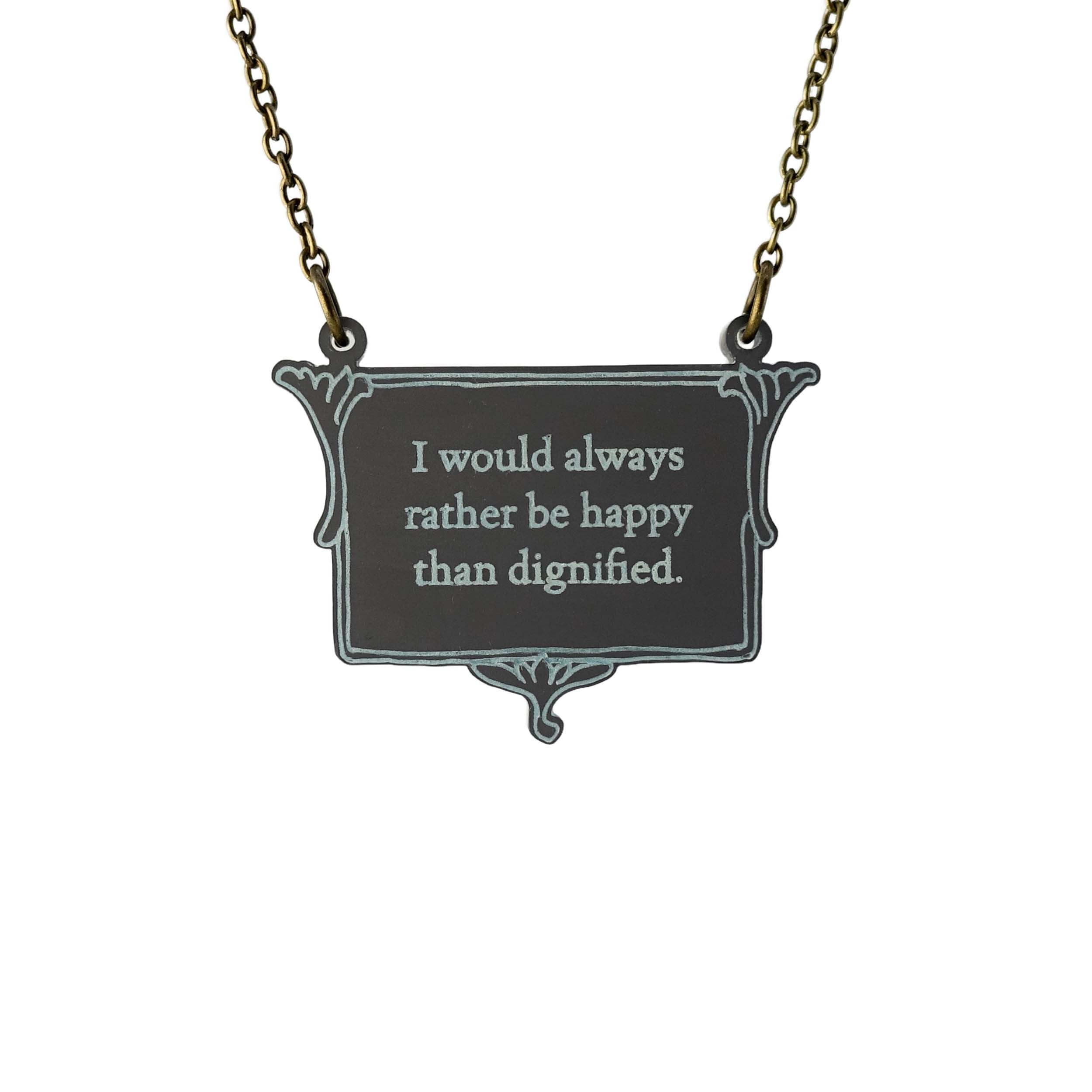A vintage style slate necklace etched with the words of Jane Eyre 'I would always rather be happy than dignified', shown hanging on an antique gold chain against a white background.